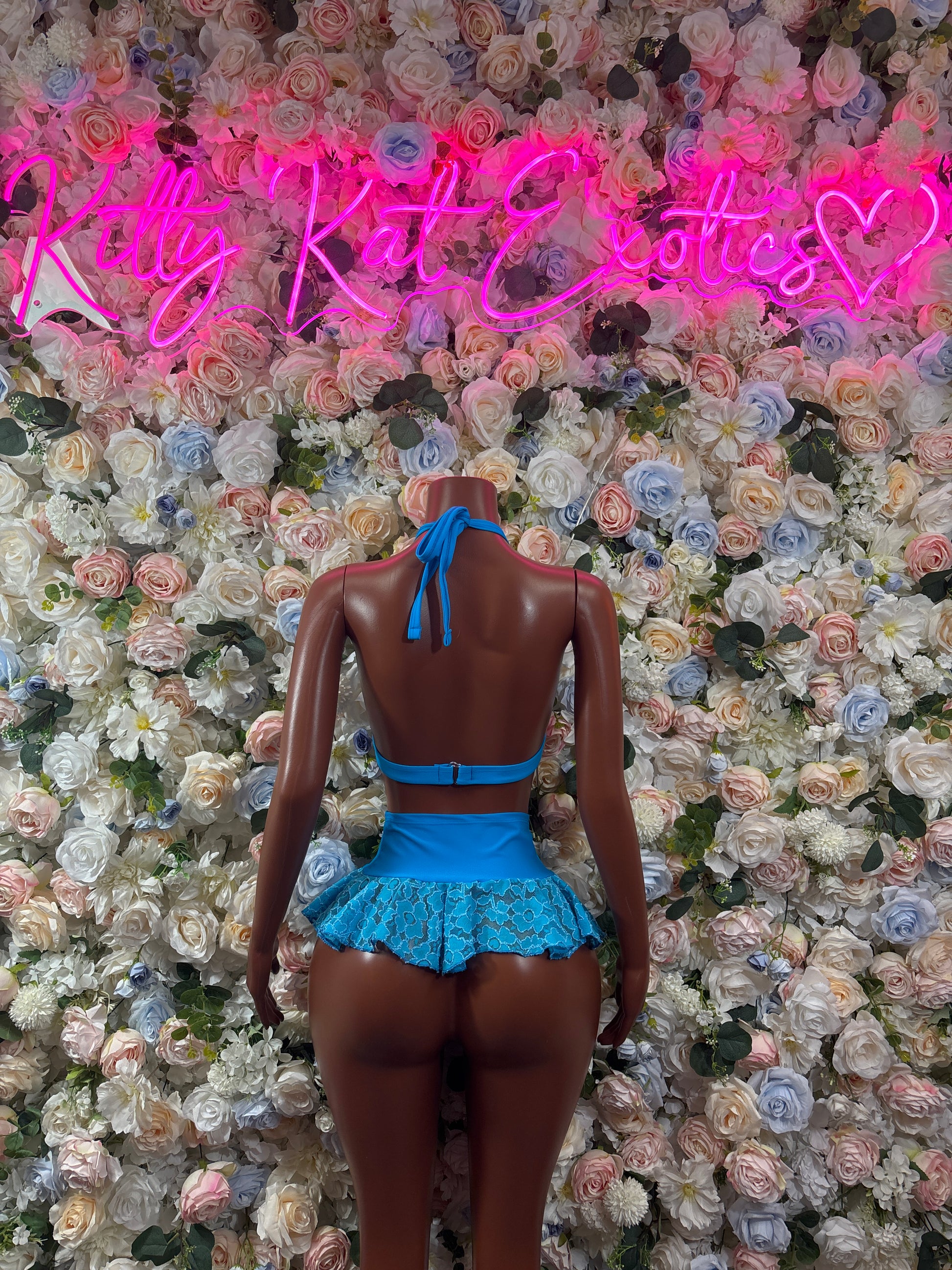 Blue lace bralette and ruffled mini skirt set, back view with tied straps