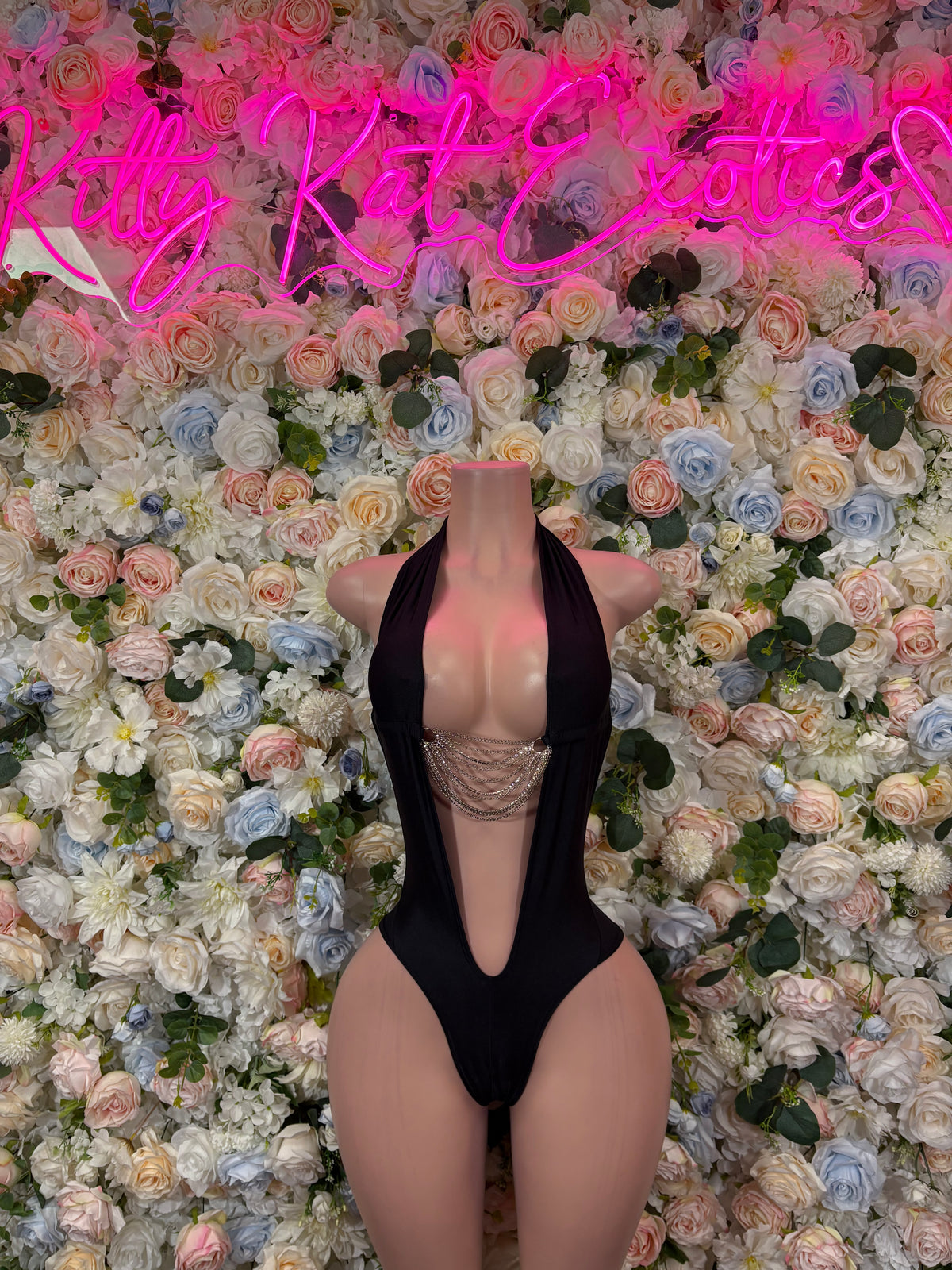 Black open-back bodysuit with high-cut legs and crisscross tie straps