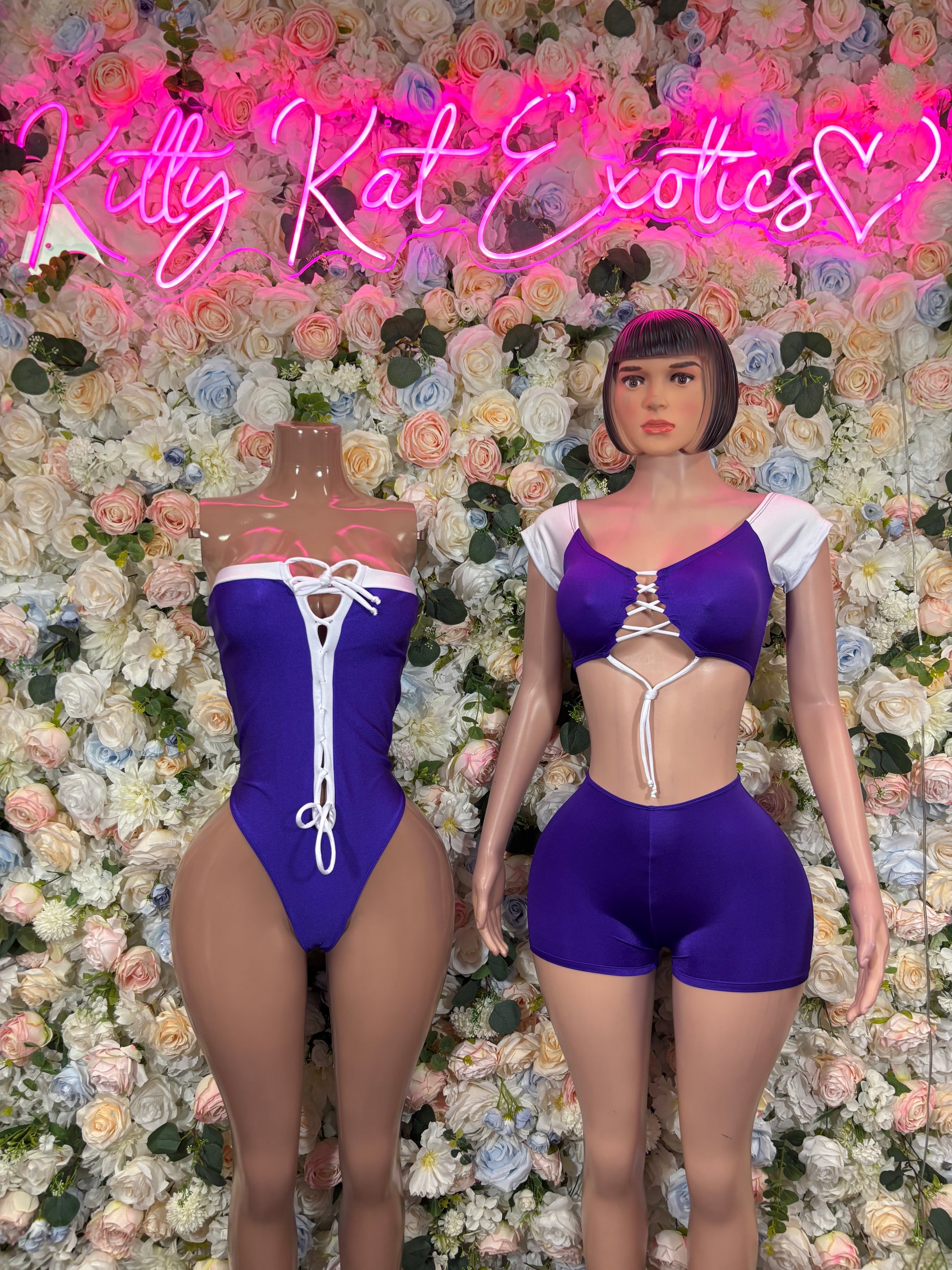 Purple satin-style bodysuit costume with white lace-up front and cutout waist