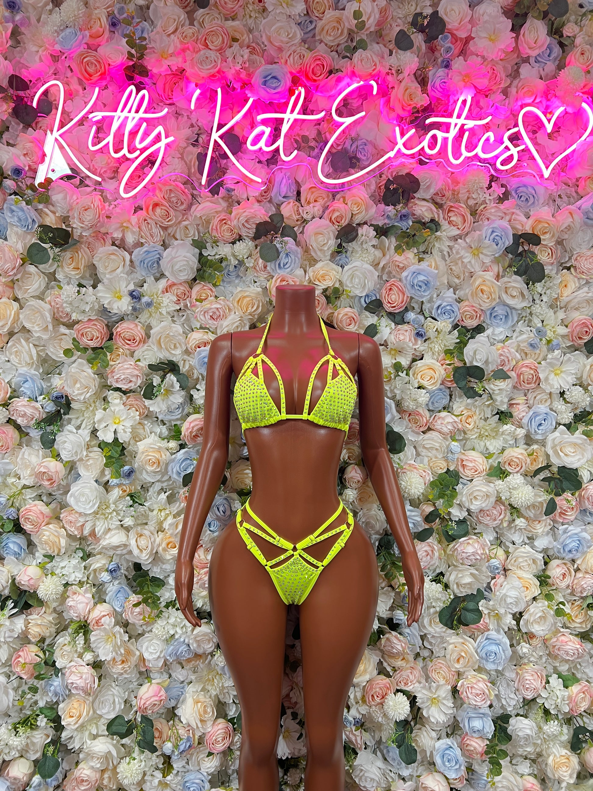 Neon green rhinestone bikini set with triangle bra and crisscross strap bottom on mannequin