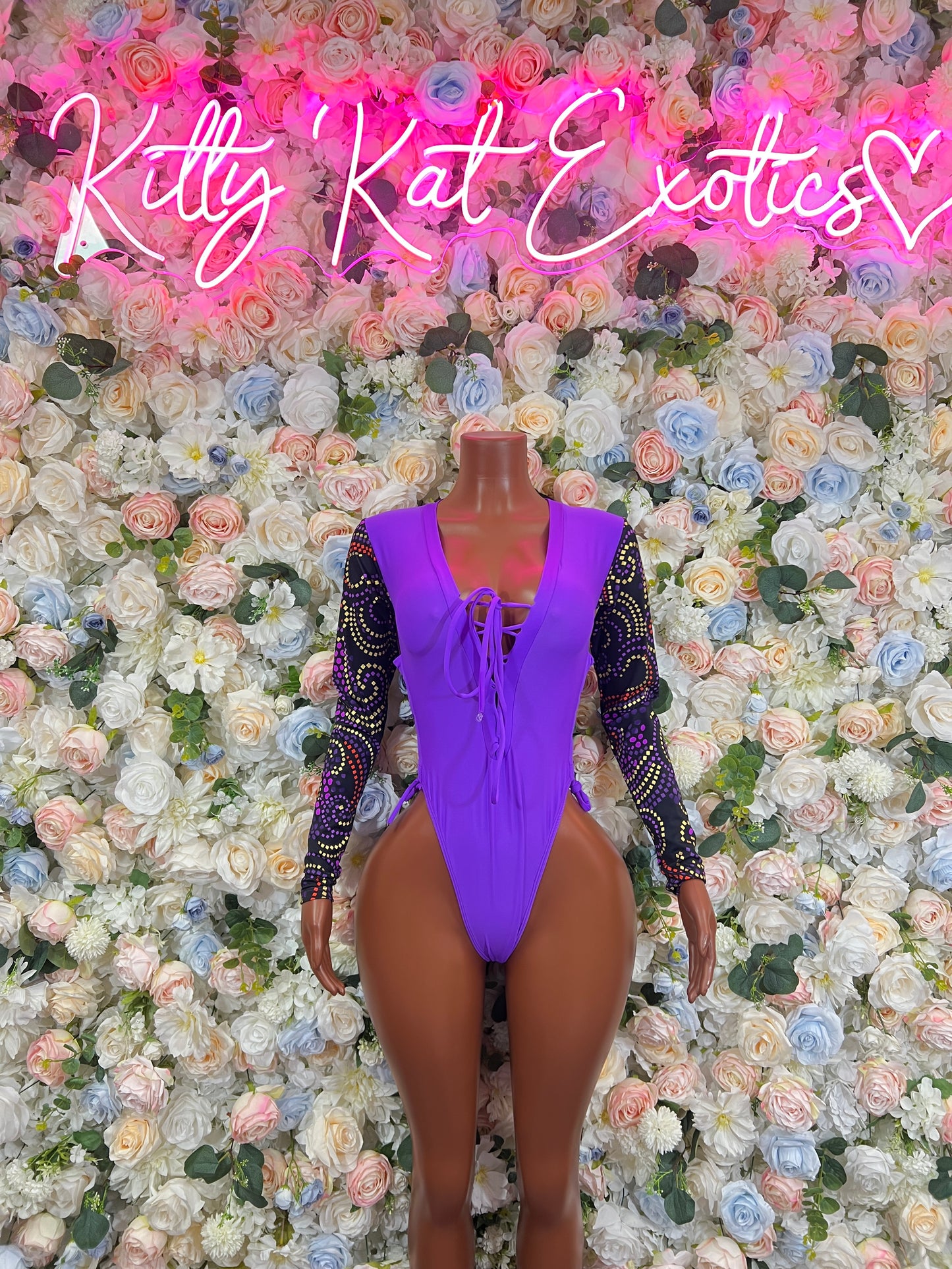 Purple lace long-sleeve bodysuit with crisscross front cutout