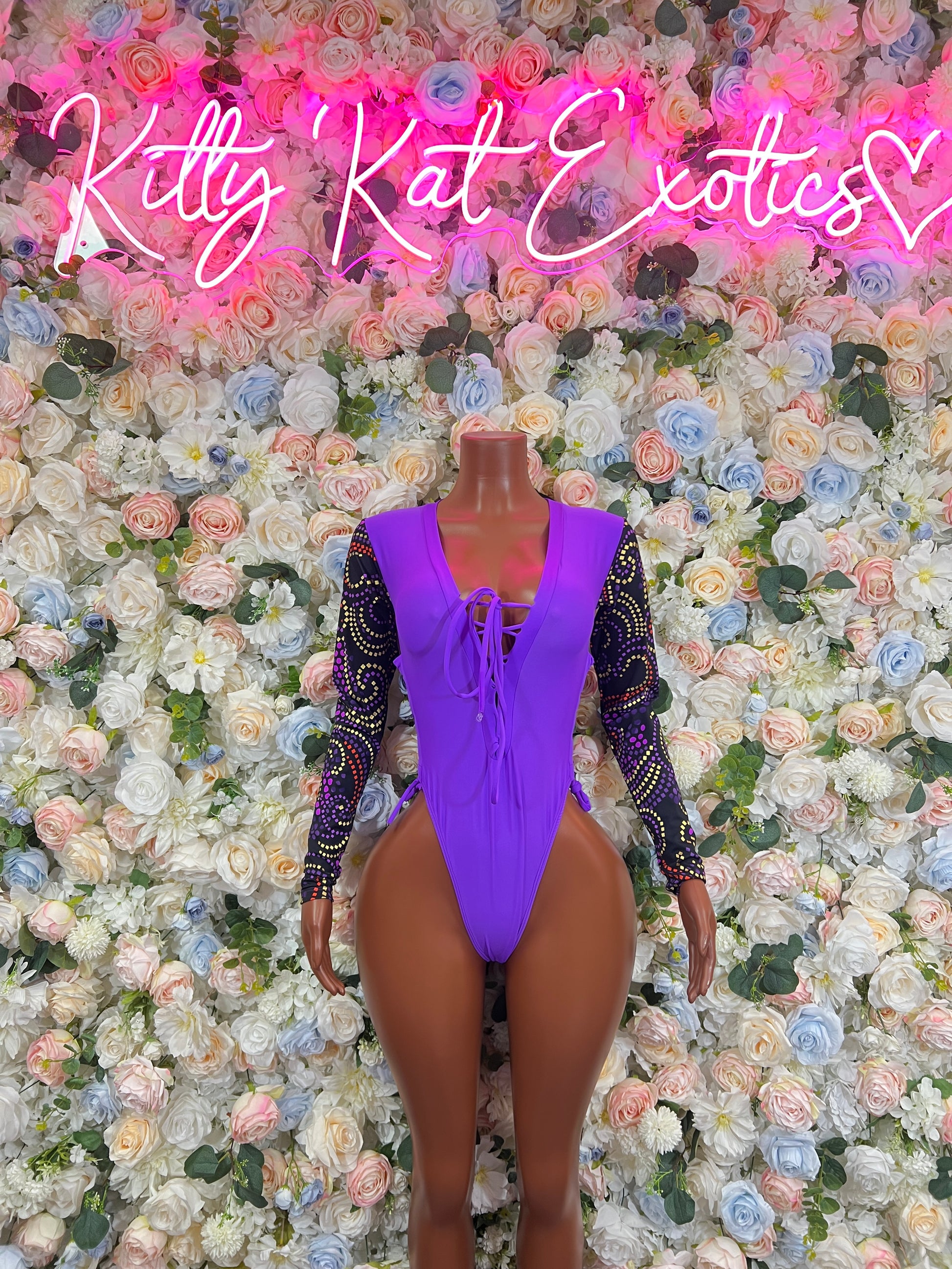 Purple lace long-sleeve bodysuit with crisscross front cutout