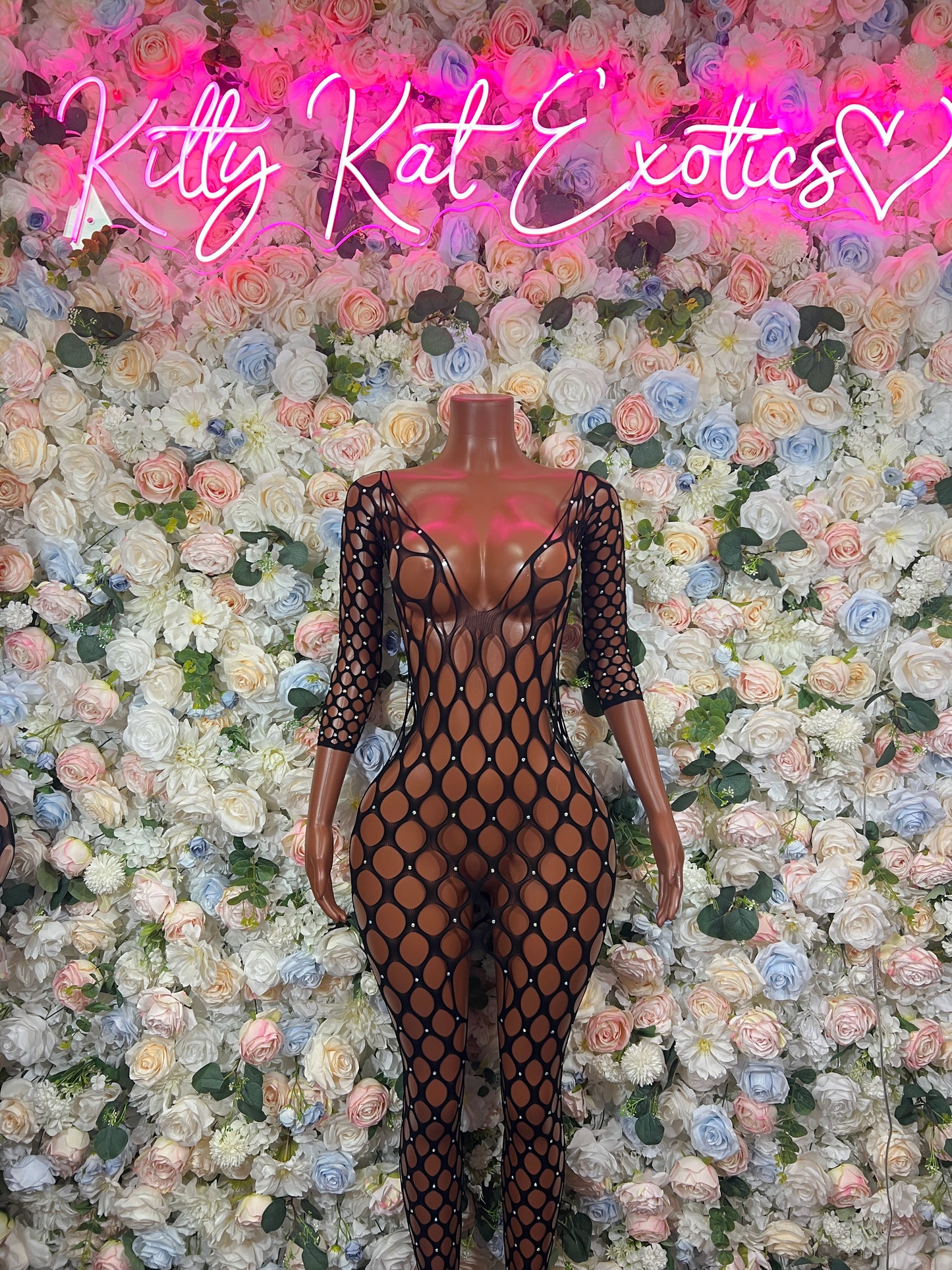 Black fishnet long-sleeve bodysuit with back cutouts and crisscross mesh