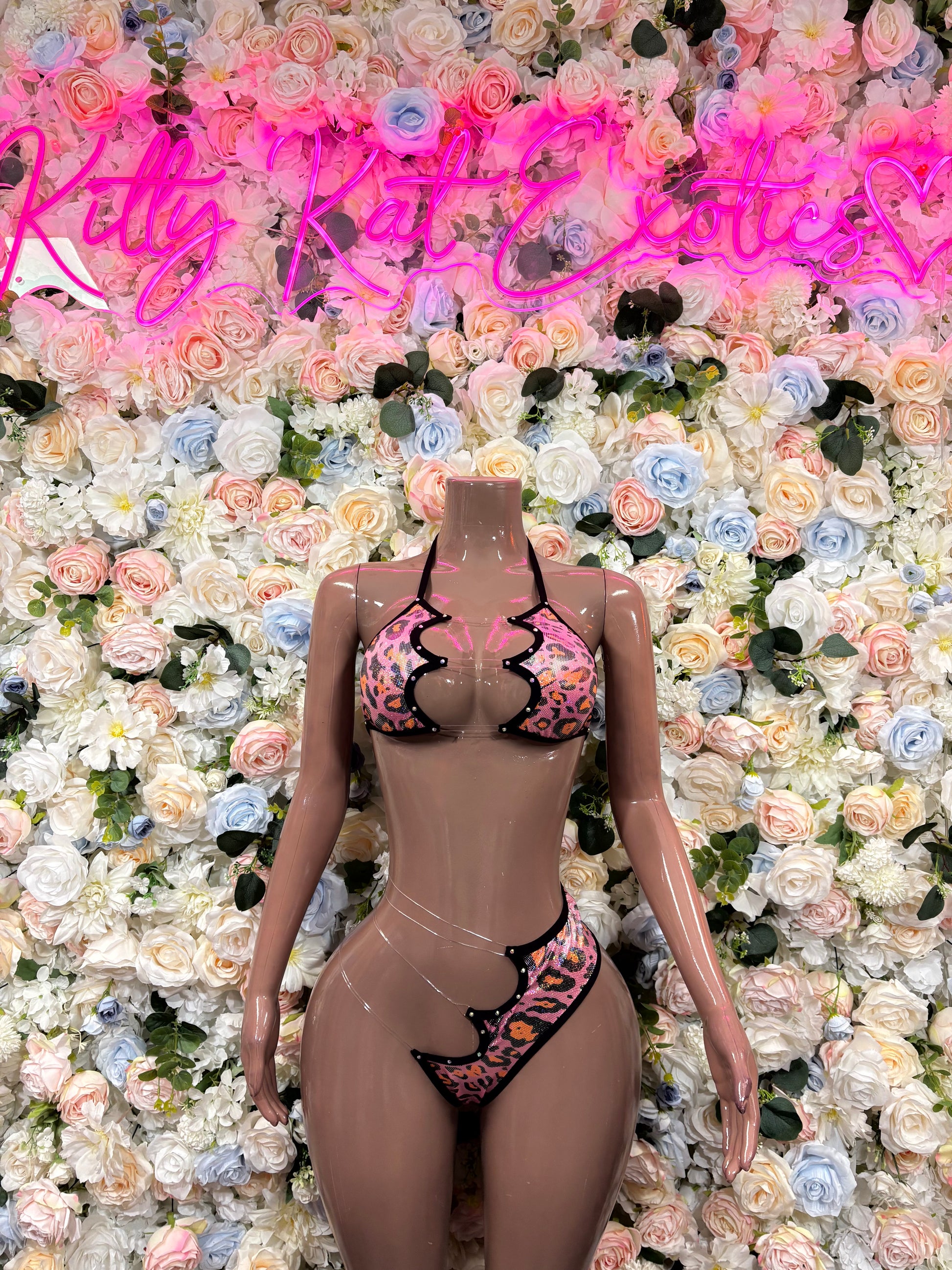 Pink leopard-print lingerie set with black trim, front view, tie-string accents