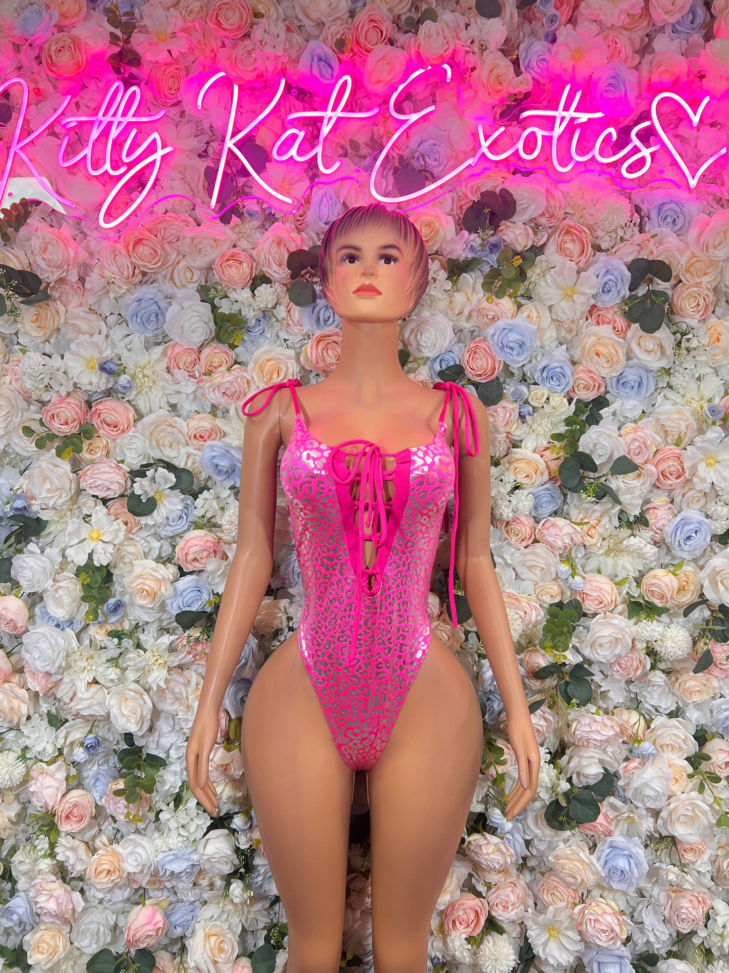 Hot pink metallic cheetah one-piece bodysuit with lace-up neckline and side cutouts