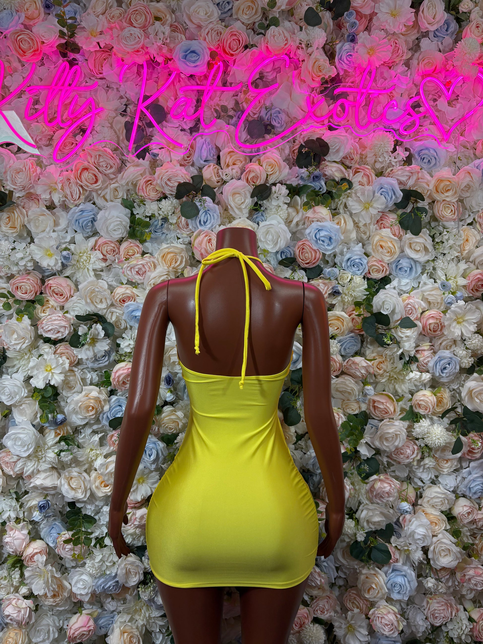 Yellow halter mini dress, tied halter straps on back, back view