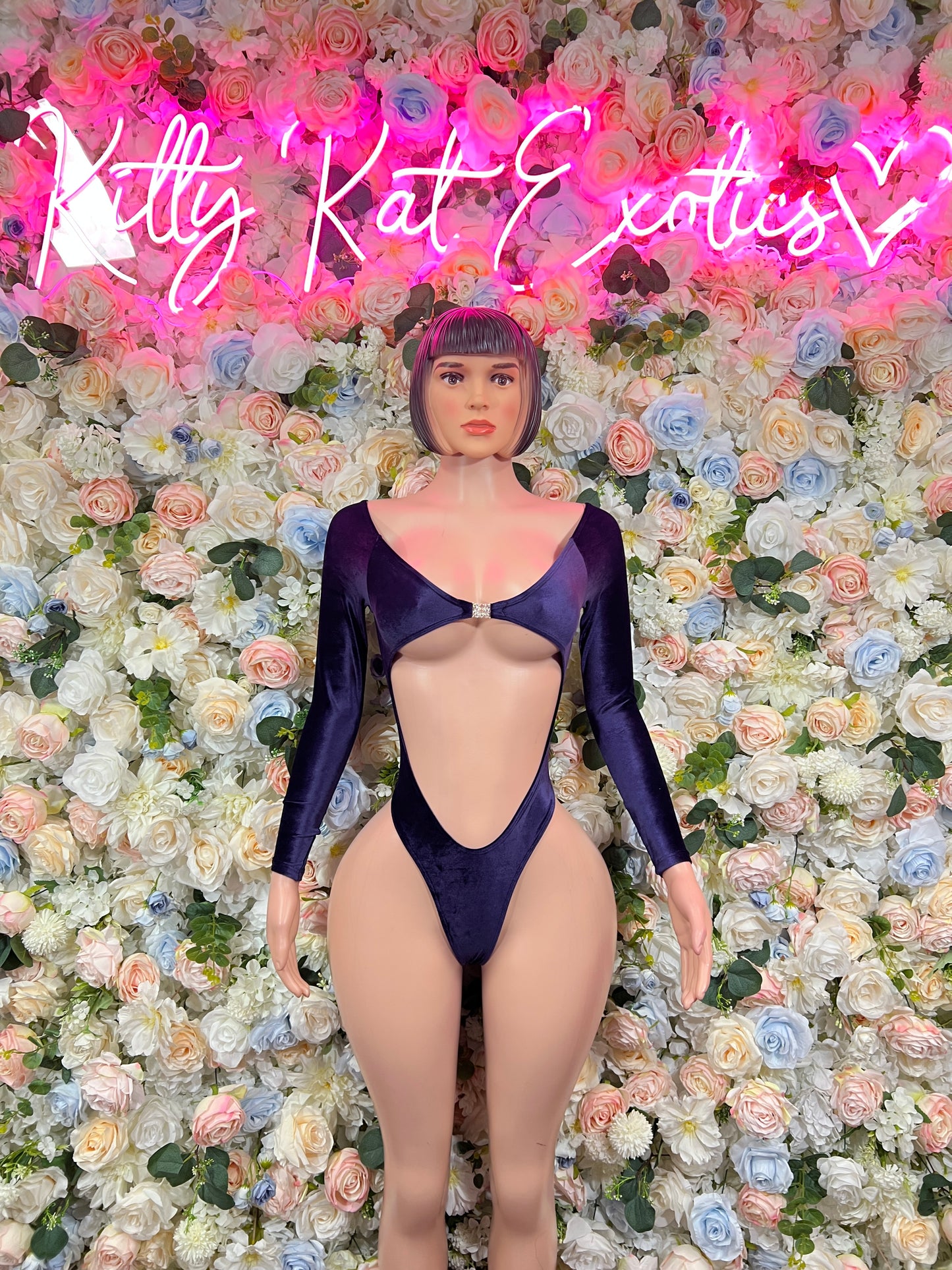 One-piece blue velvet bodysuit with long sleeves and deep V front cutout