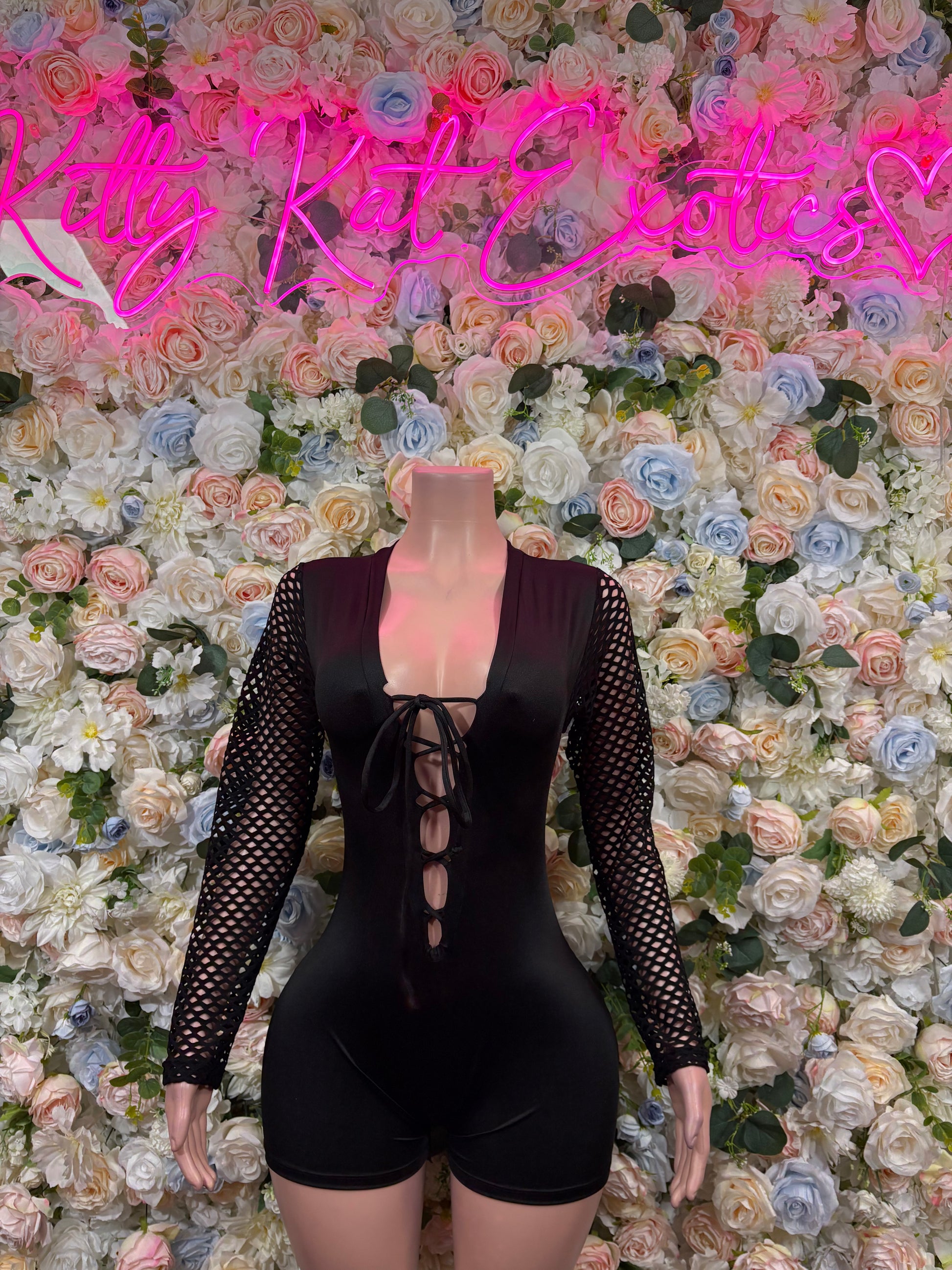 Black lace-sleeve one-piece bodysuit with crisscross front lace-up and shorts cut
