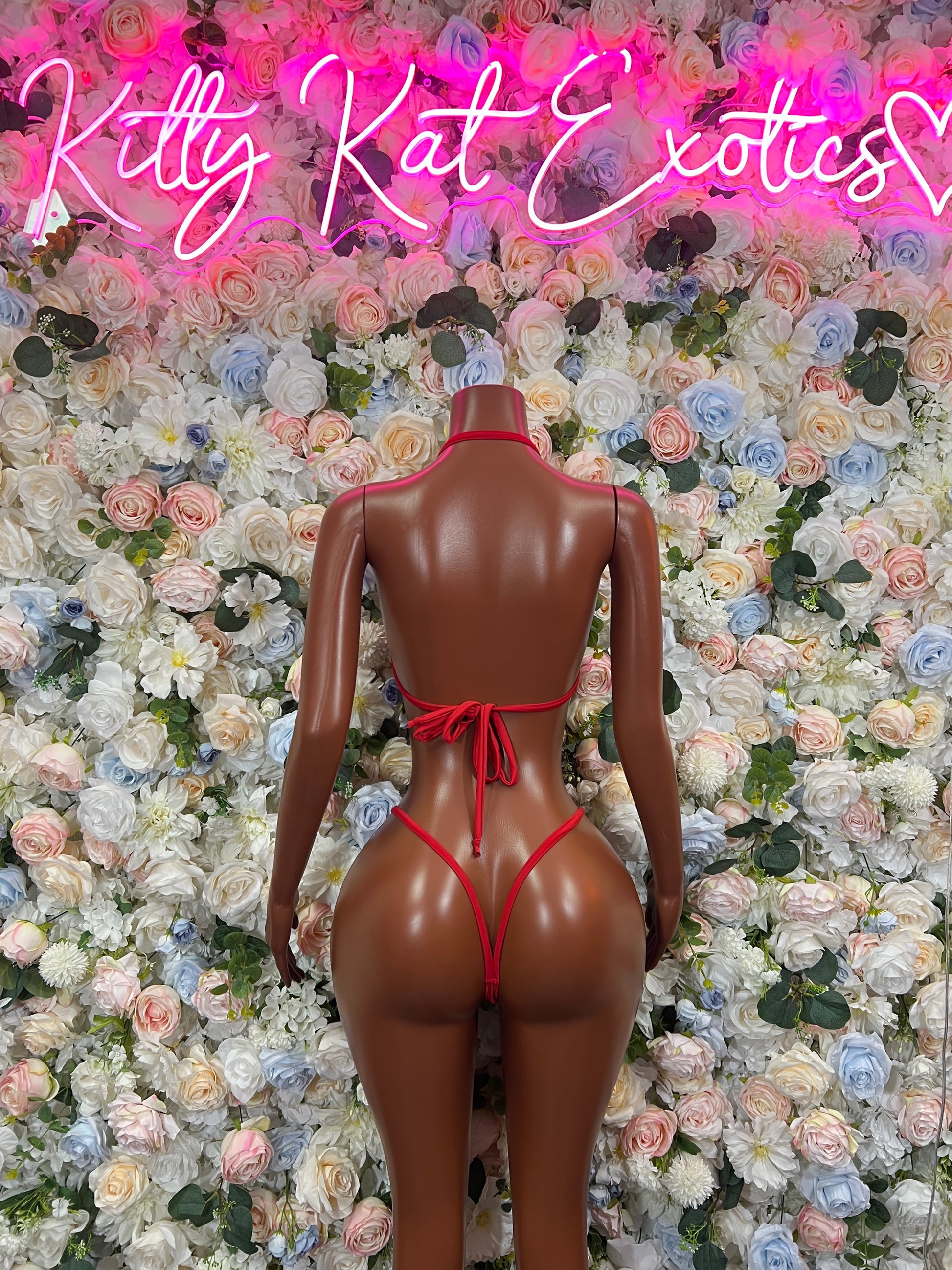 Red bikini two-piece with crop top and tie-back string bottoms (rear view)