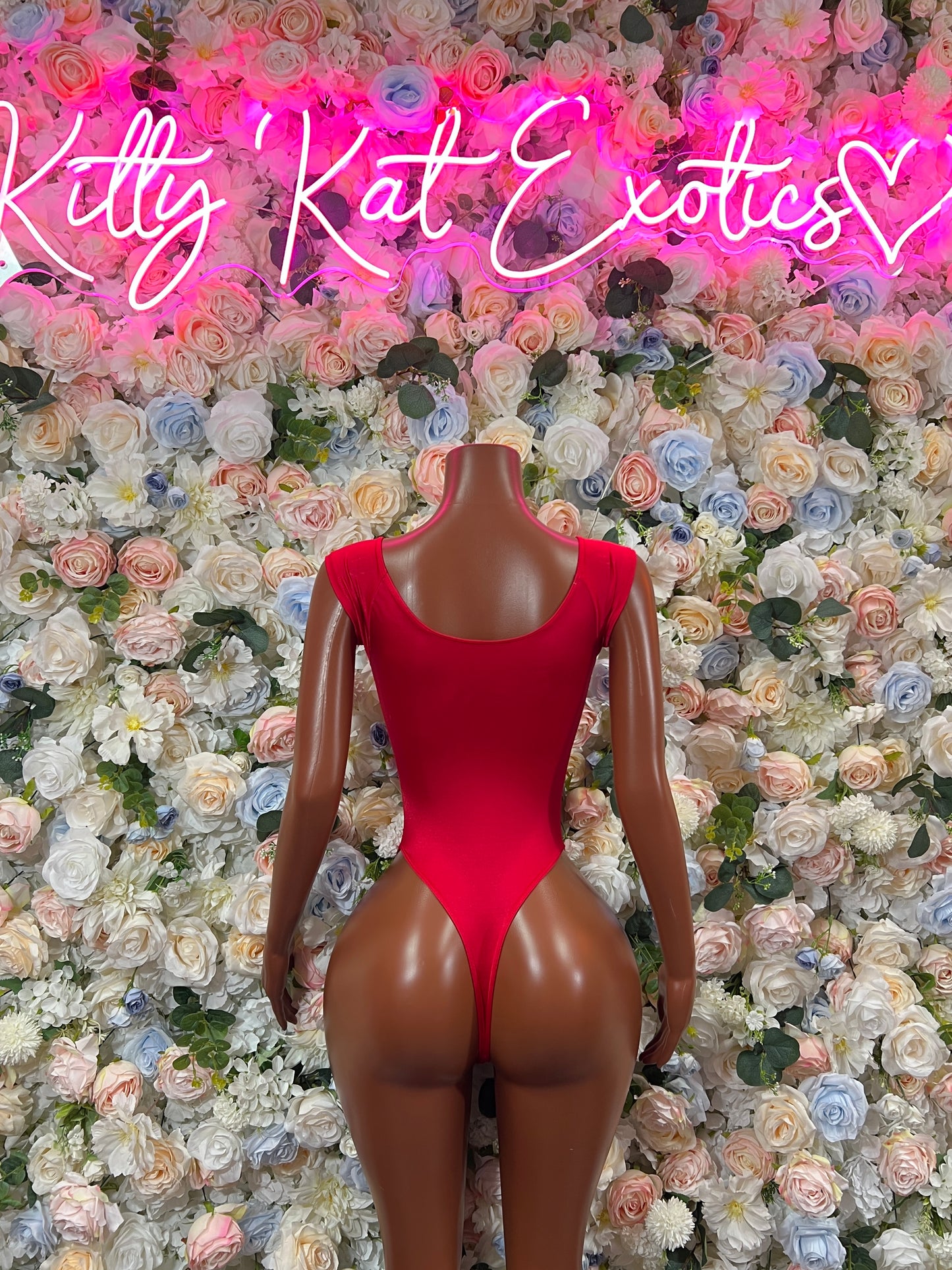 Red one-piece bodysuit with open back, long sleeves, thong cut