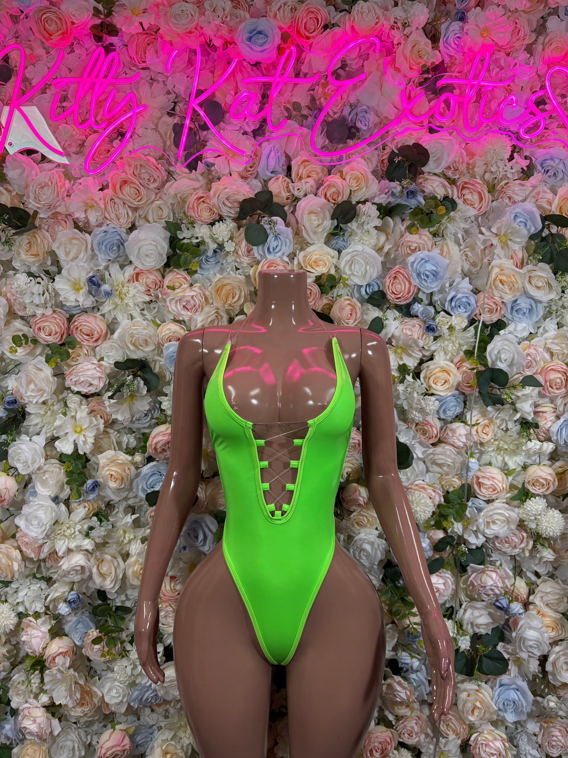 Neon green high-cut one-piece with mesh cutouts at bust and front