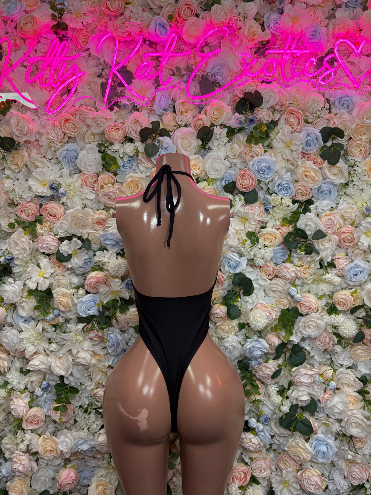 Black lace-up rave bodysuit with strappy open back and tie closure