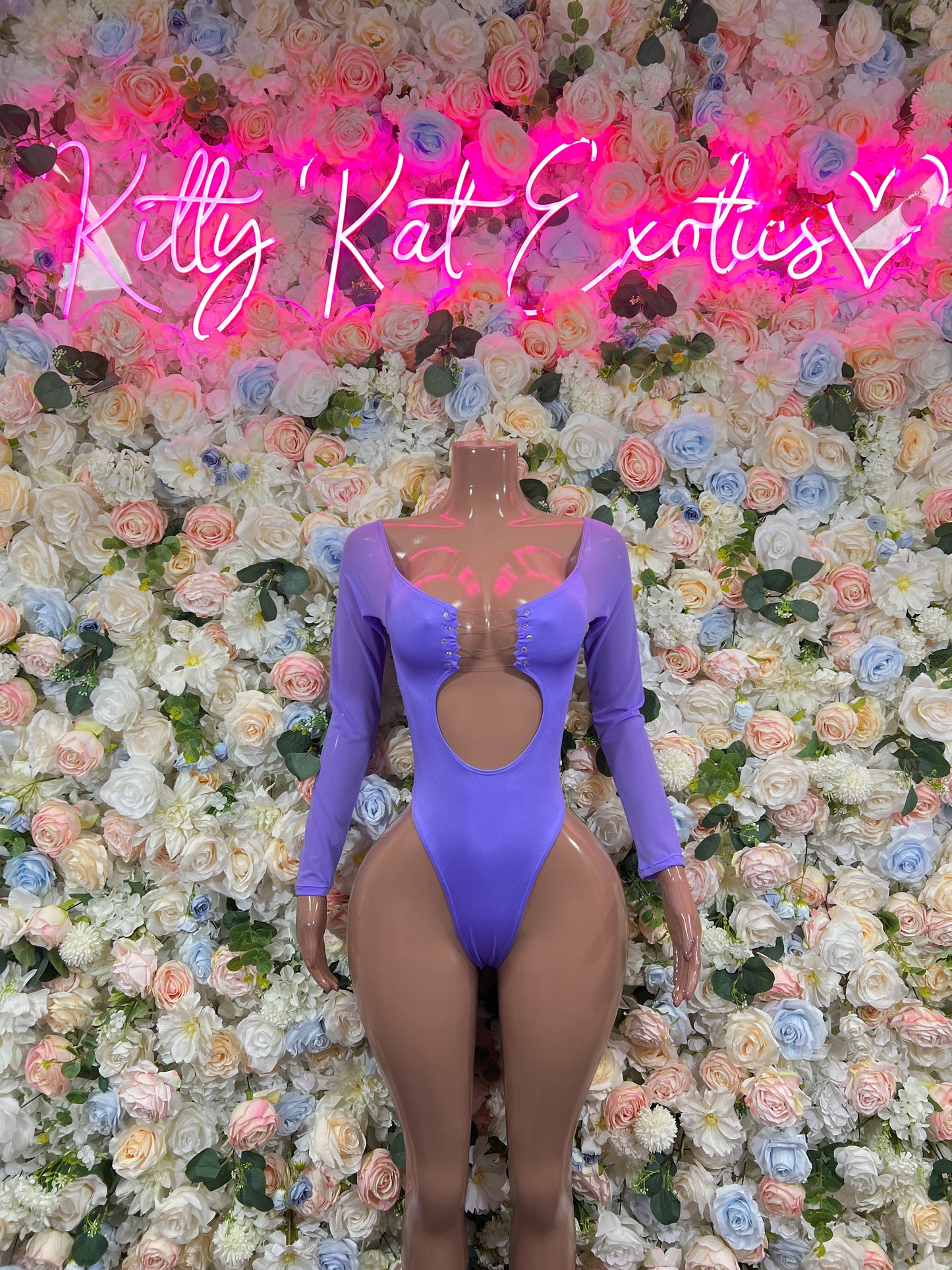 Purple one-piece bodysuit with long sleeves and open back cutout