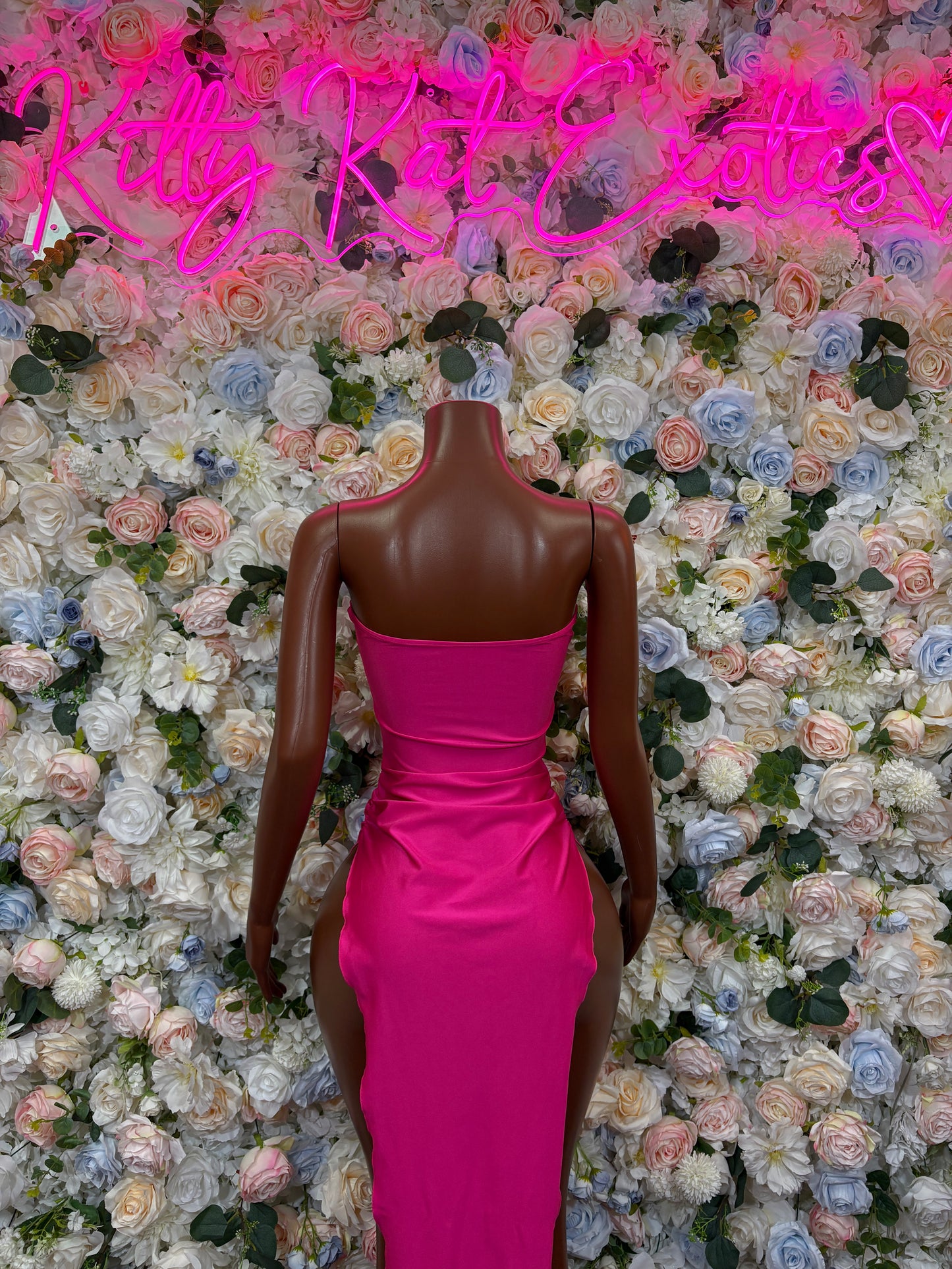 Magenta fitted gown back view with V-back and ruched waist on mannequin