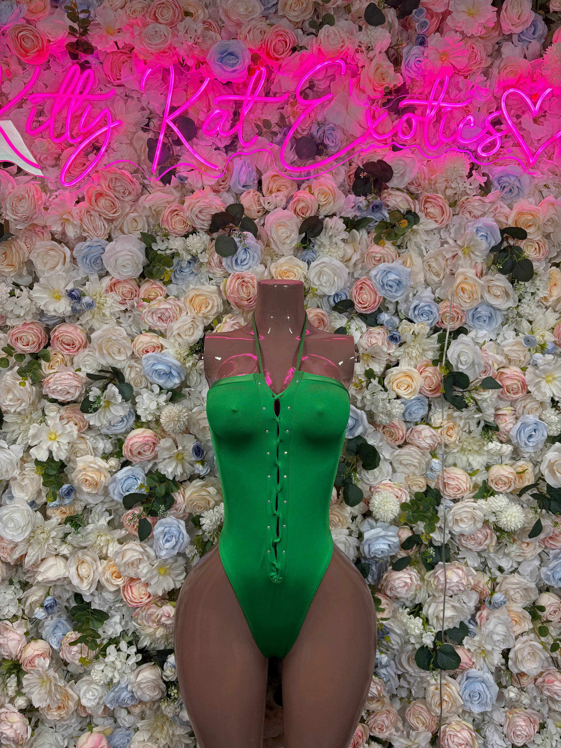Green sleeveless rave bodysuit with halter neckline and snap-button front