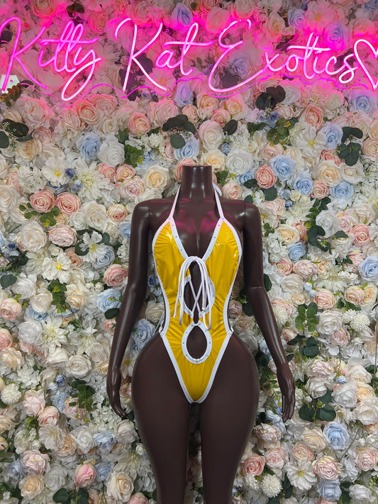 Yellow shiny latex bodysuit with white lace-up front and oval cutout, high-cut