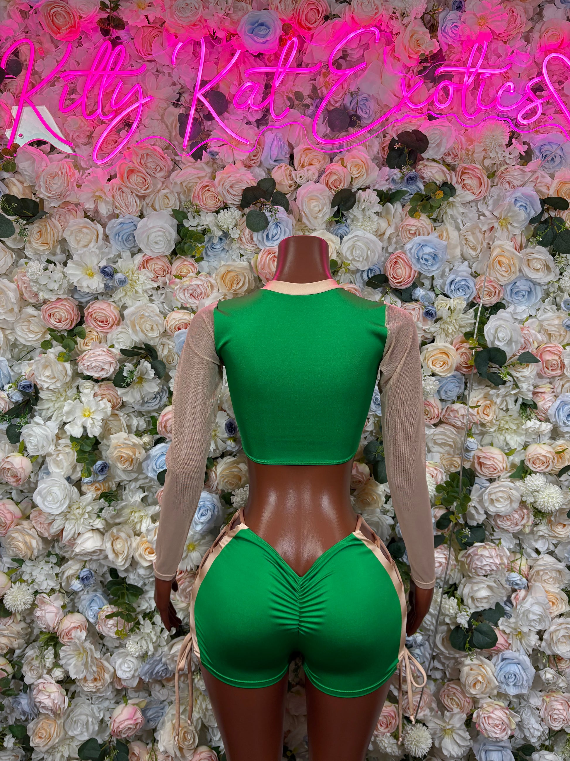 Green bodysuit with sheer sleeves and crisscross lace-up open back detail