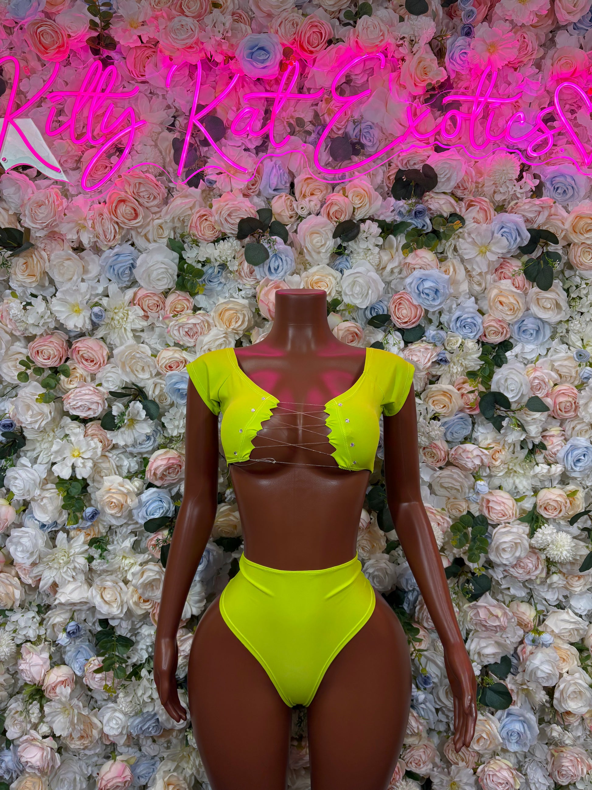 Neon green rave two-piece: off-shoulder crop top and high-cut bikini bottoms