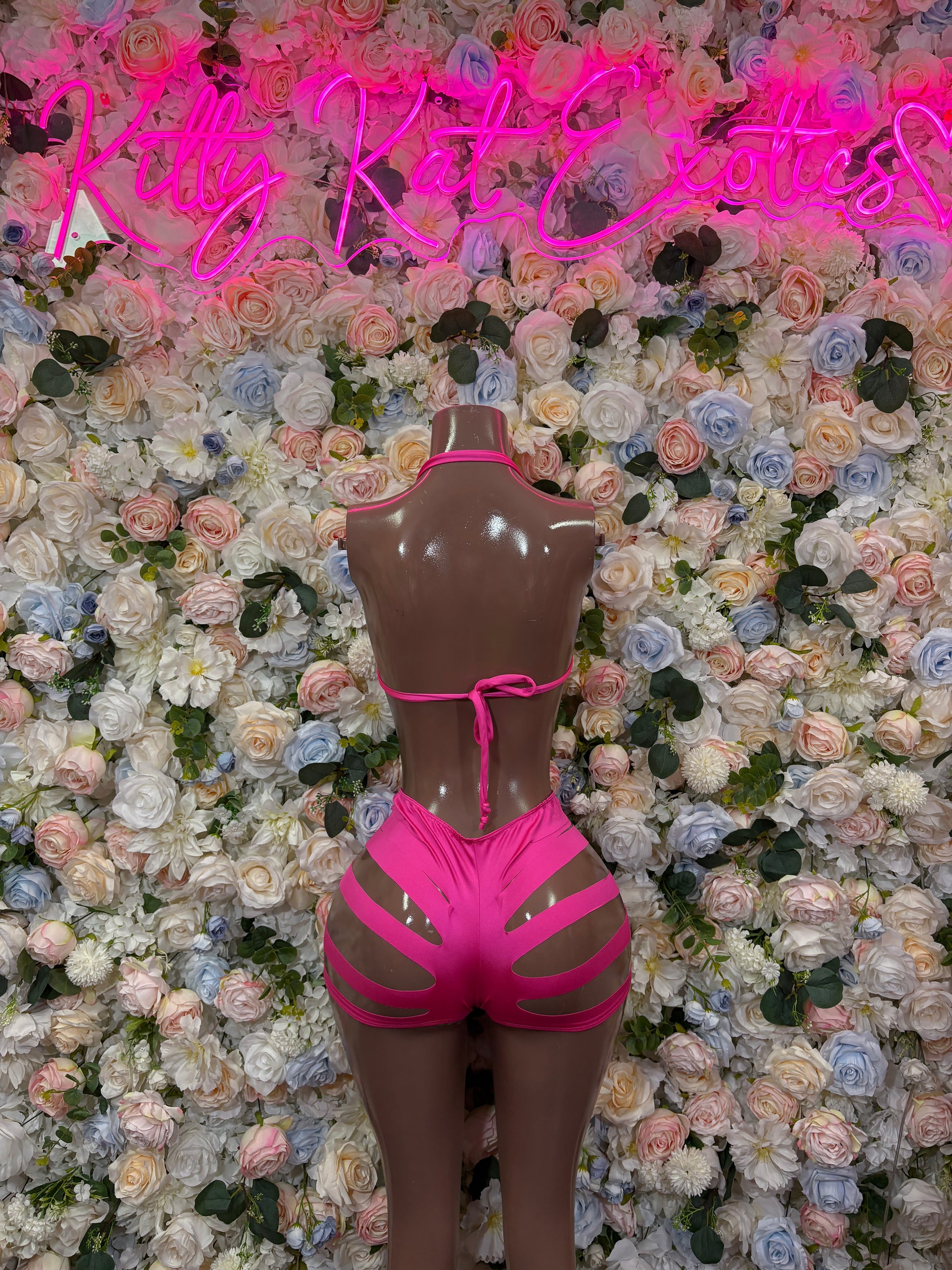 Pink two-piece rave wear set with halter crop top and high-waist striped bottoms