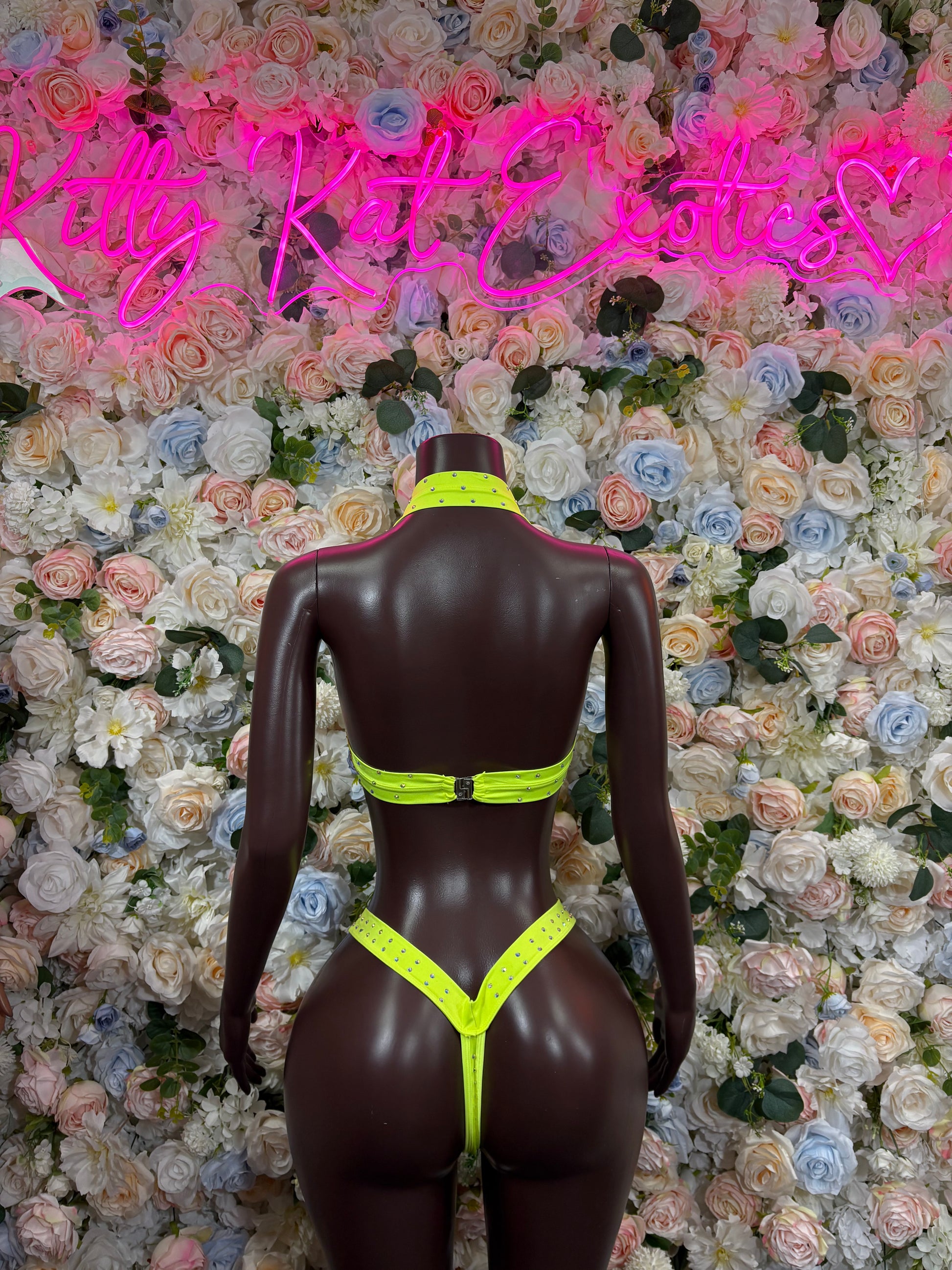 Neon green rhinestone-trim bikini set on mannequin, back view with thong cut