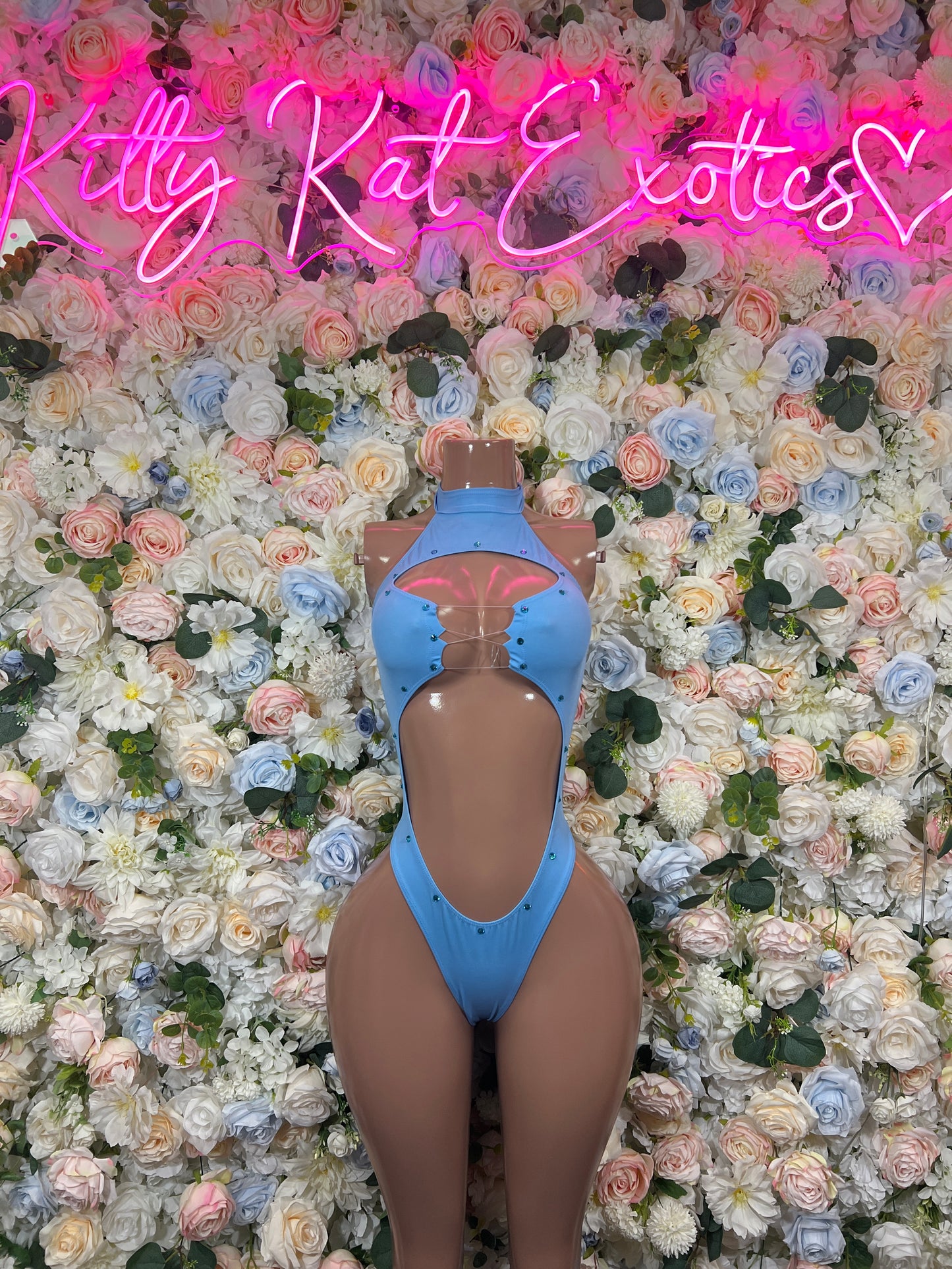 Light blue high-neck bodysuit with central back cutout and strap details