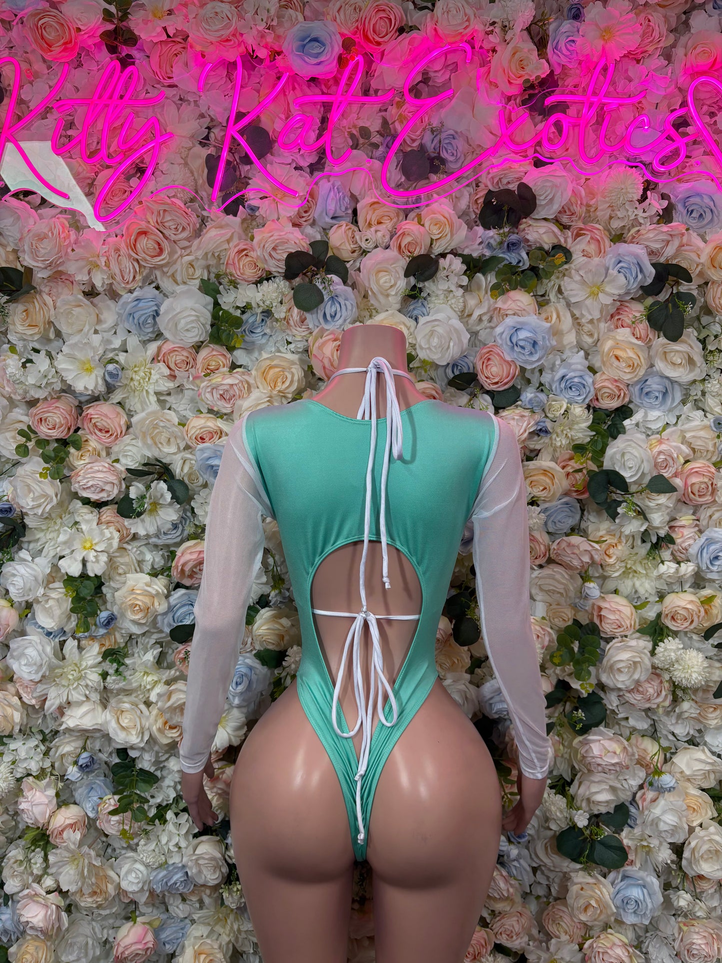Back of aqua teal sequined bodysuit with strappy lace-up back and sheer long sleeves
