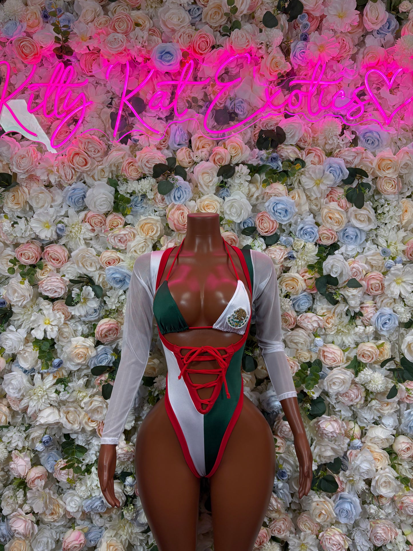 Women’s bikini bodysuit with red lace-up front, green bust, white and red trim
