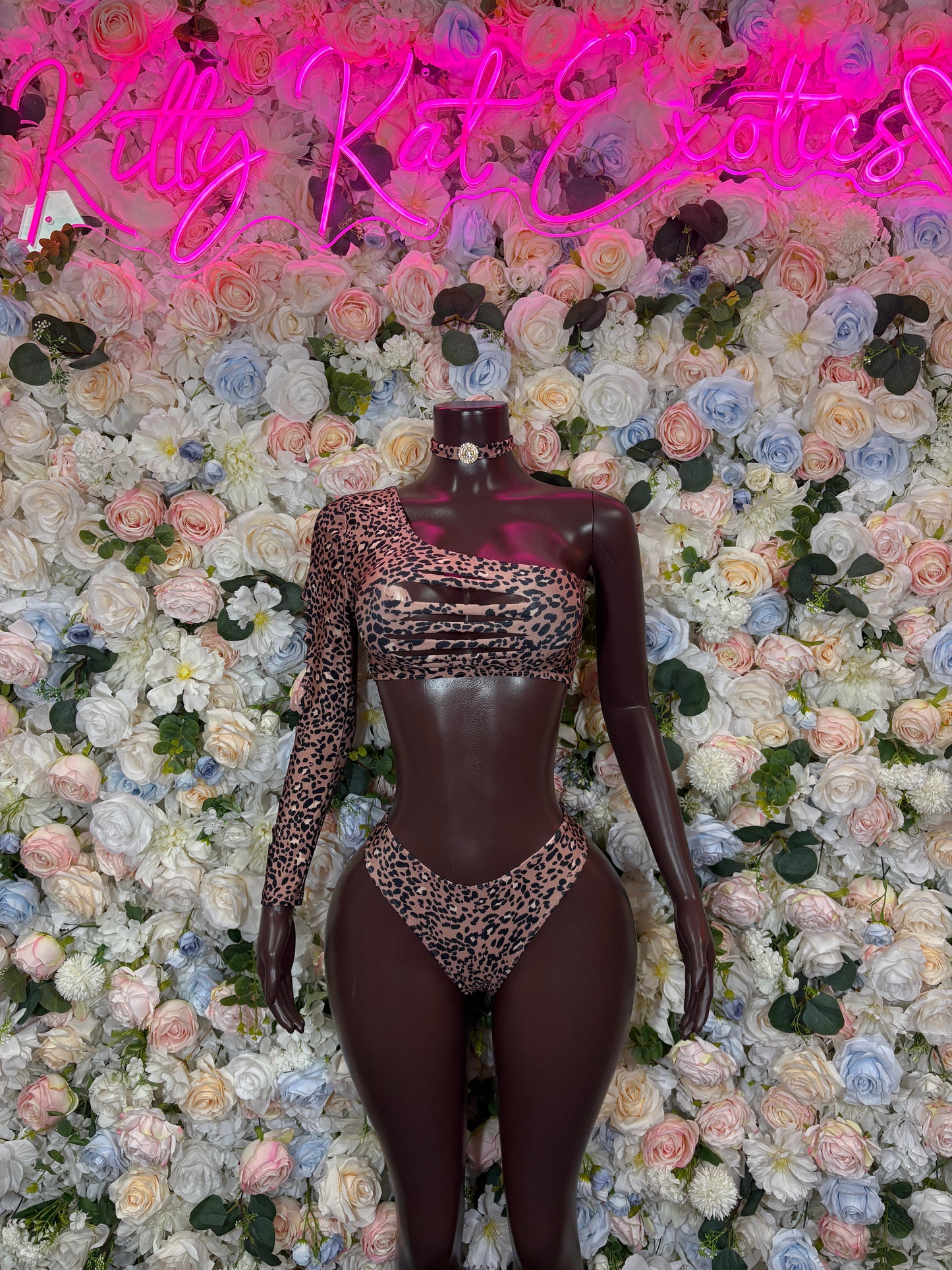 Leopard print two-piece dancewear set on mannequin, long-sleeve top with high-cut bottoms