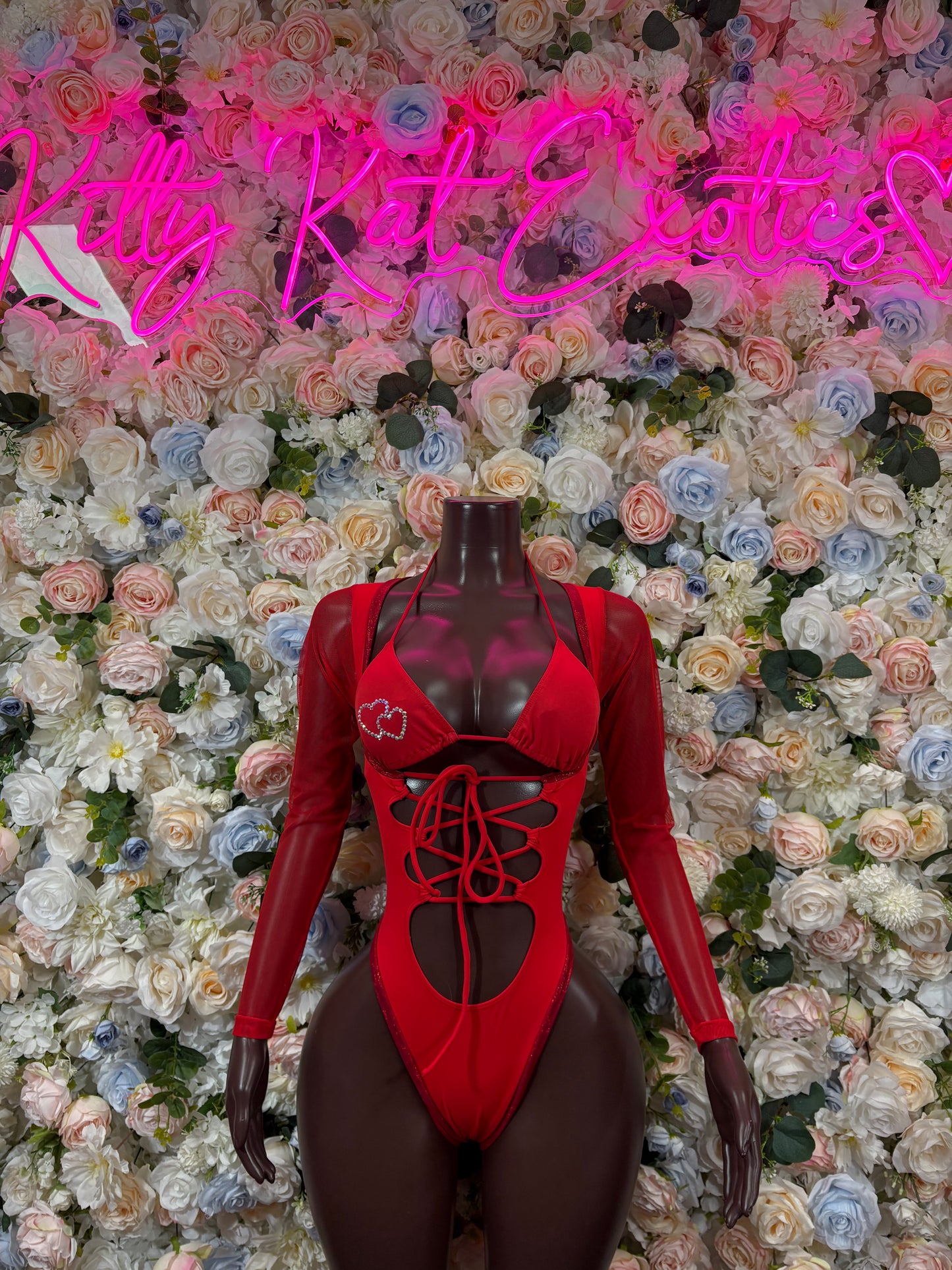 Red heart print bodysuit with long sleeves and lace-up front, V-neck