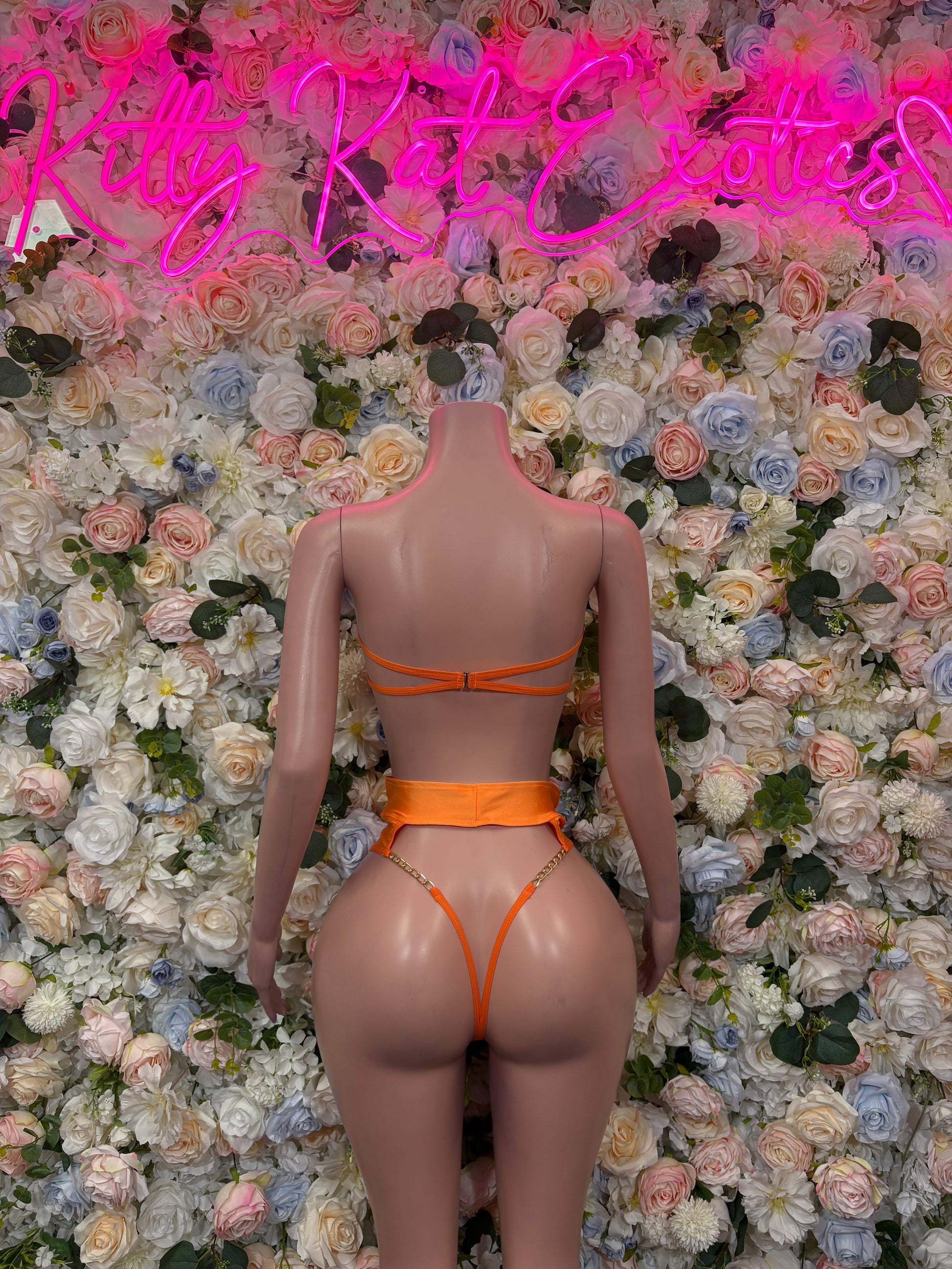 Orange two-piece dancewear set, back view, strappy triangle top and high-cut bottoms