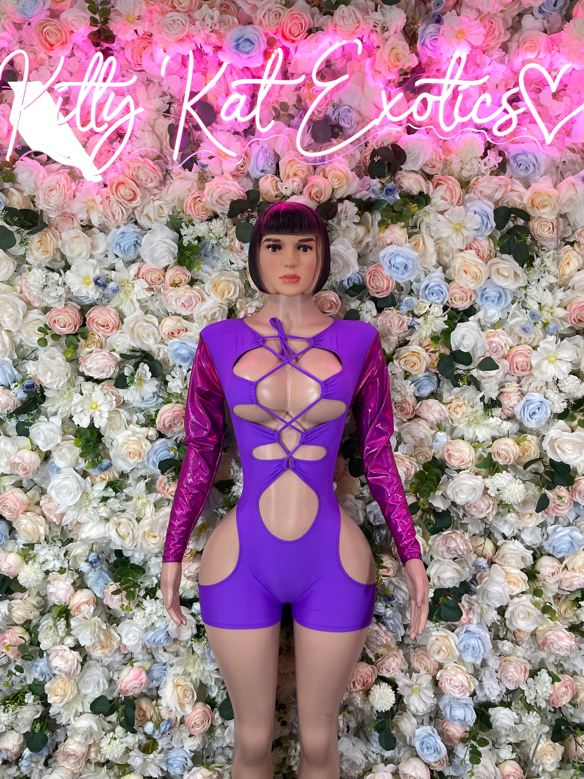 Purple one-piece bodysuit with long sleeves and crisscross lace-up front cutouts