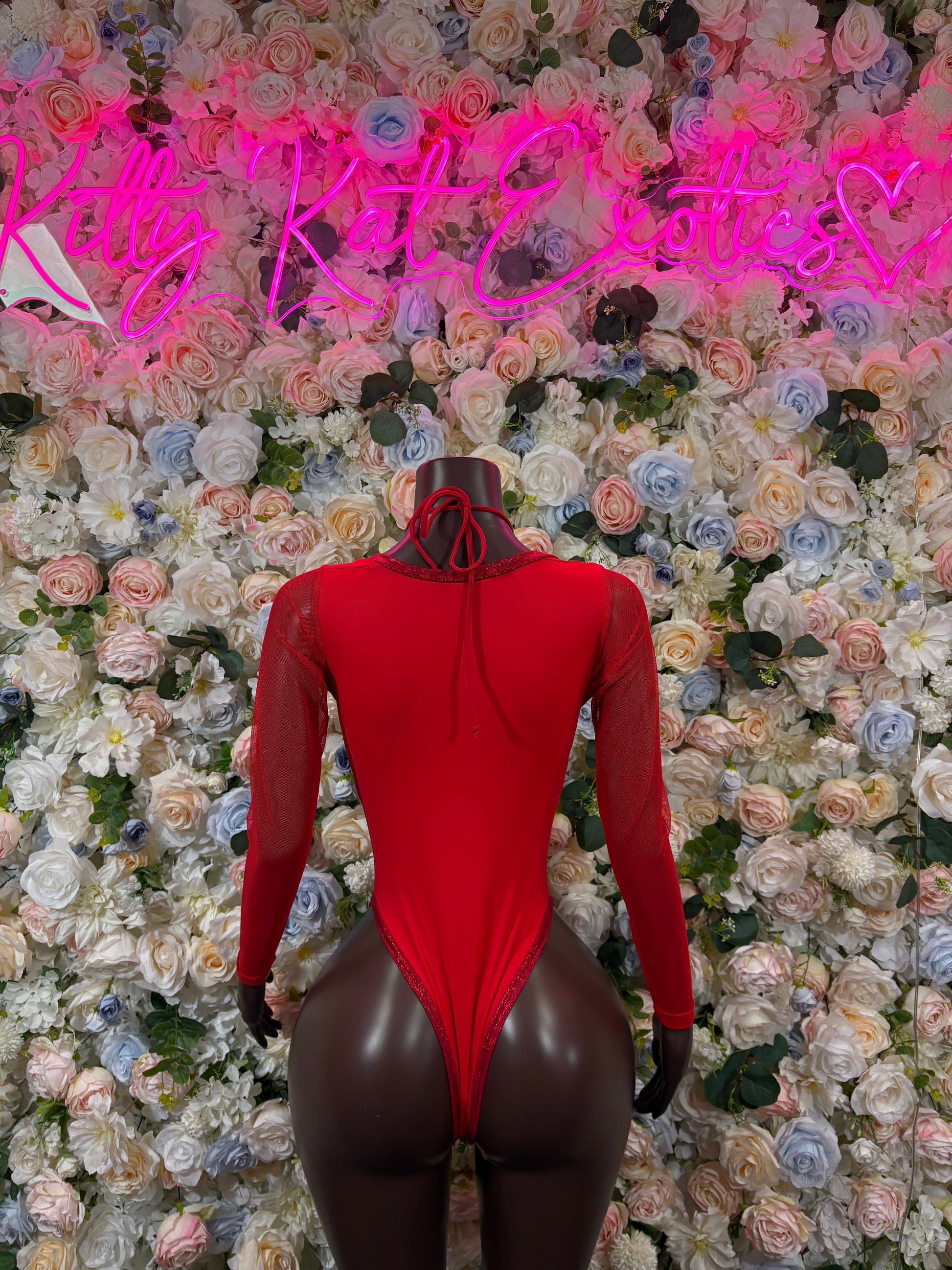 Red heart print long-sleeve bodysuit with lace-up neckline, front view