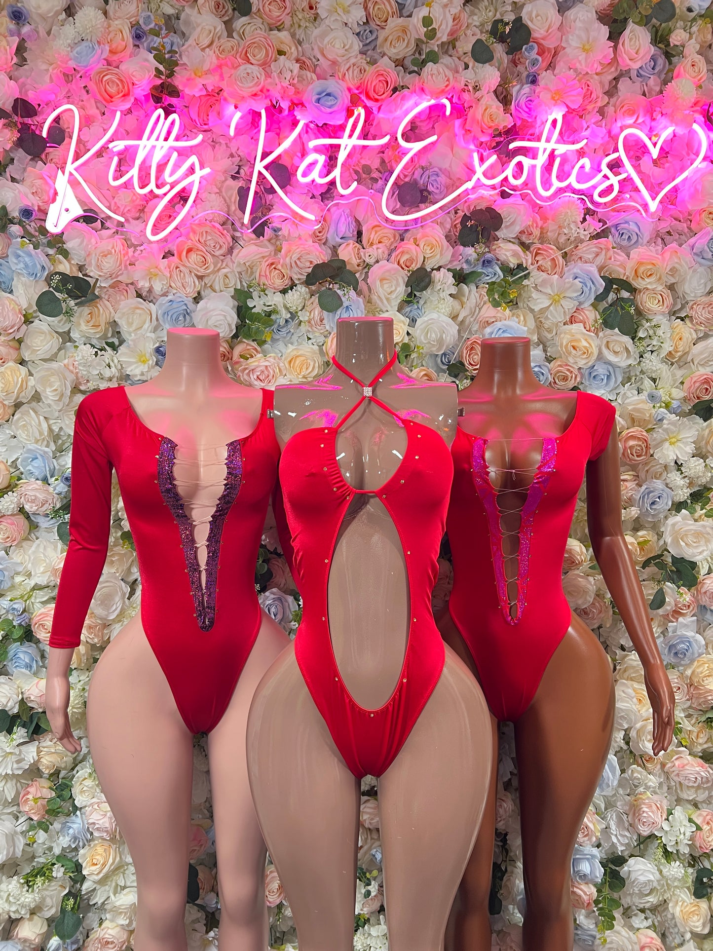 Red long-sleeve lace-trim bodysuits with V neckline shown on mannequins