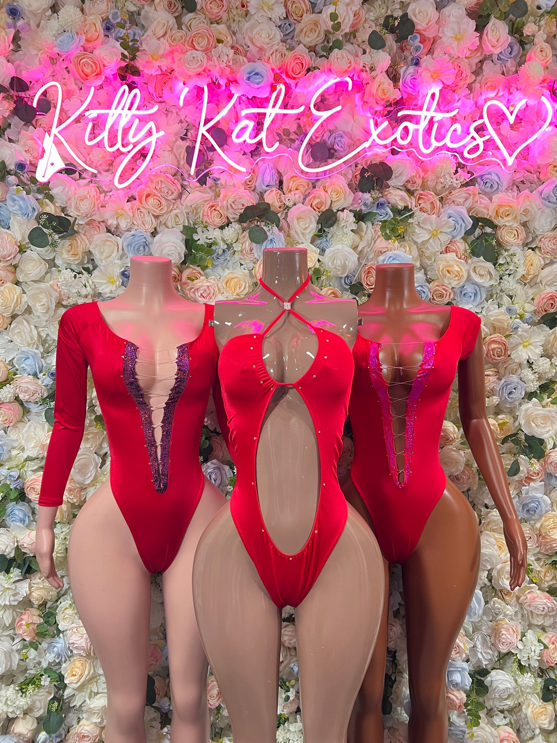 Red long-sleeve lace-trim bodysuits with V neckline shown on mannequins
