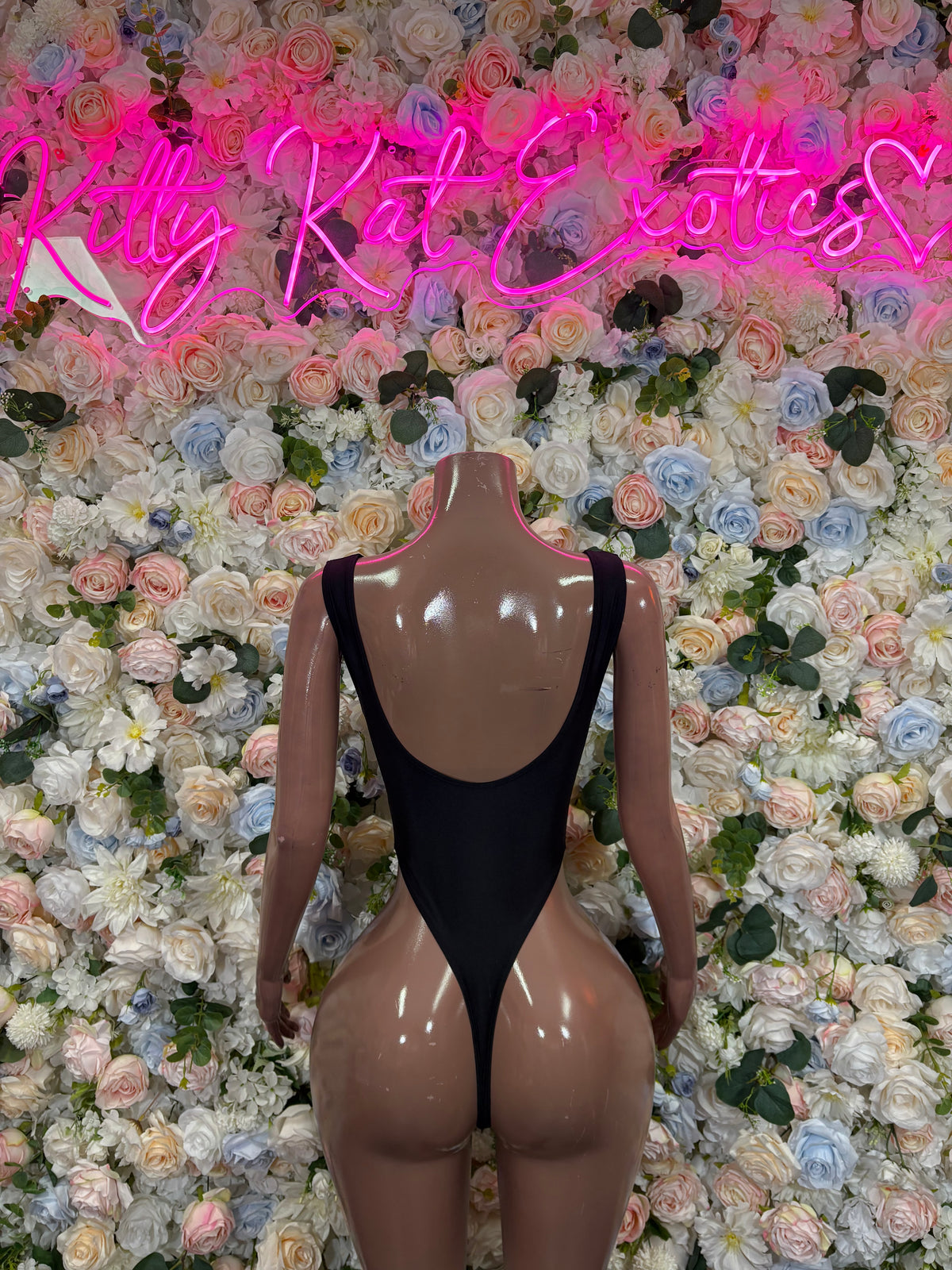 Black sleeveless cutoff bodysuit with high-cut legs and low back