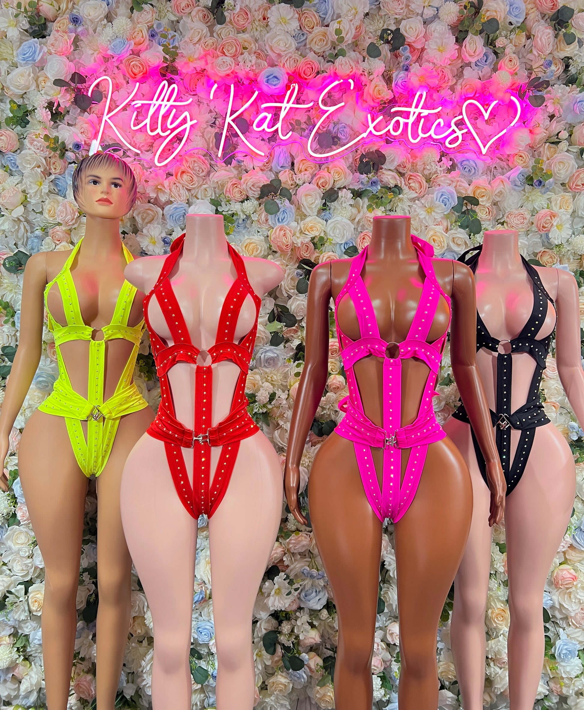 Assorted neon bodysuits with cutouts: yellow, red, pink, and black