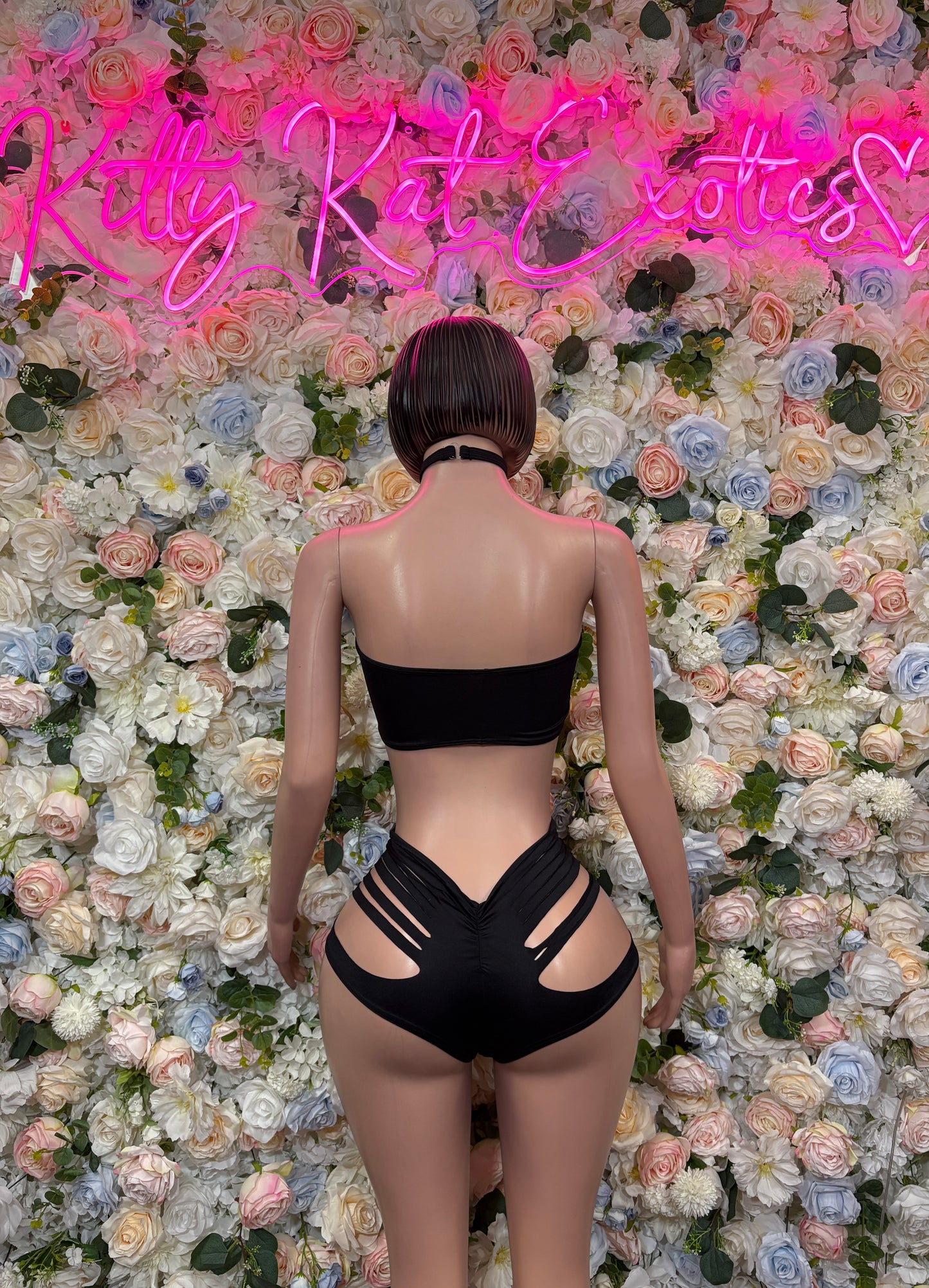 Black two-piece rave set back view: strap bandeau and strappy high-cut bottoms