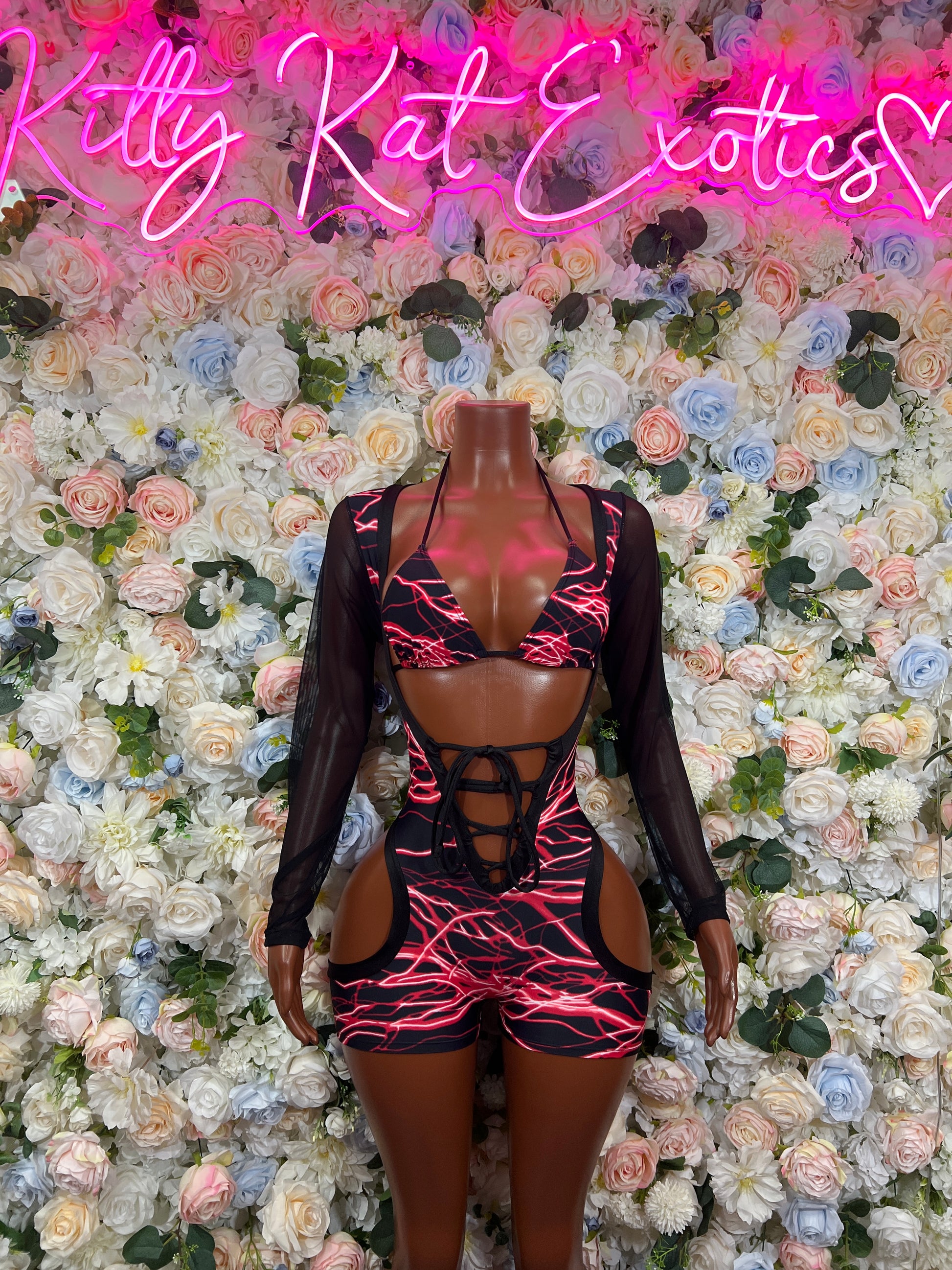 Black mesh one-piece bodysuit with red lightning print, long sleeves, cutout front