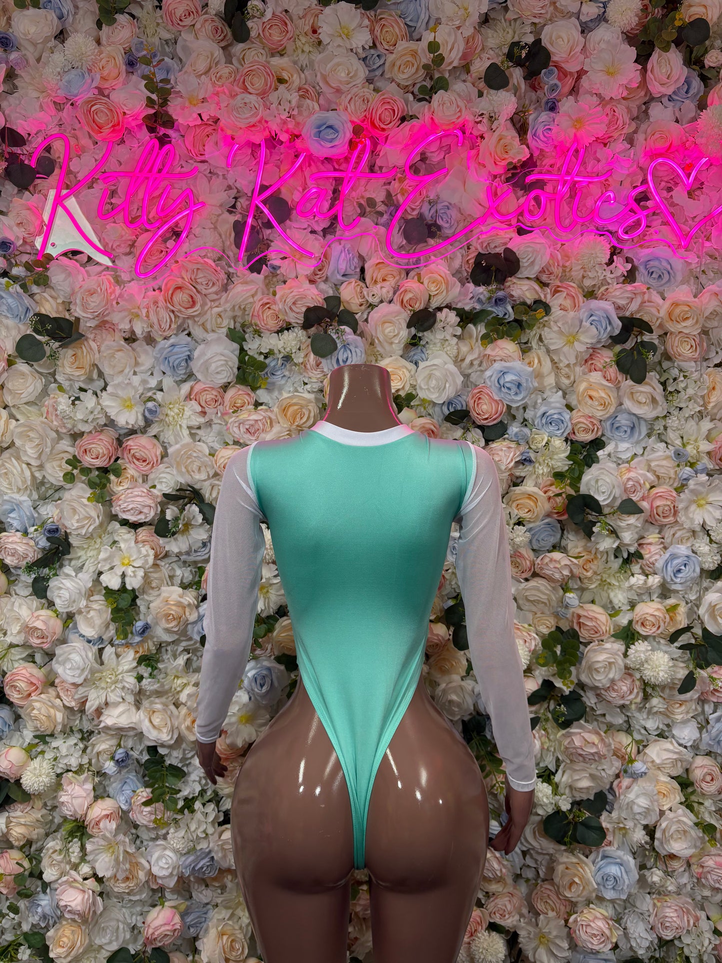 Teal cheetah-print bodysuit with open V cutout at back and long sheer sleeves