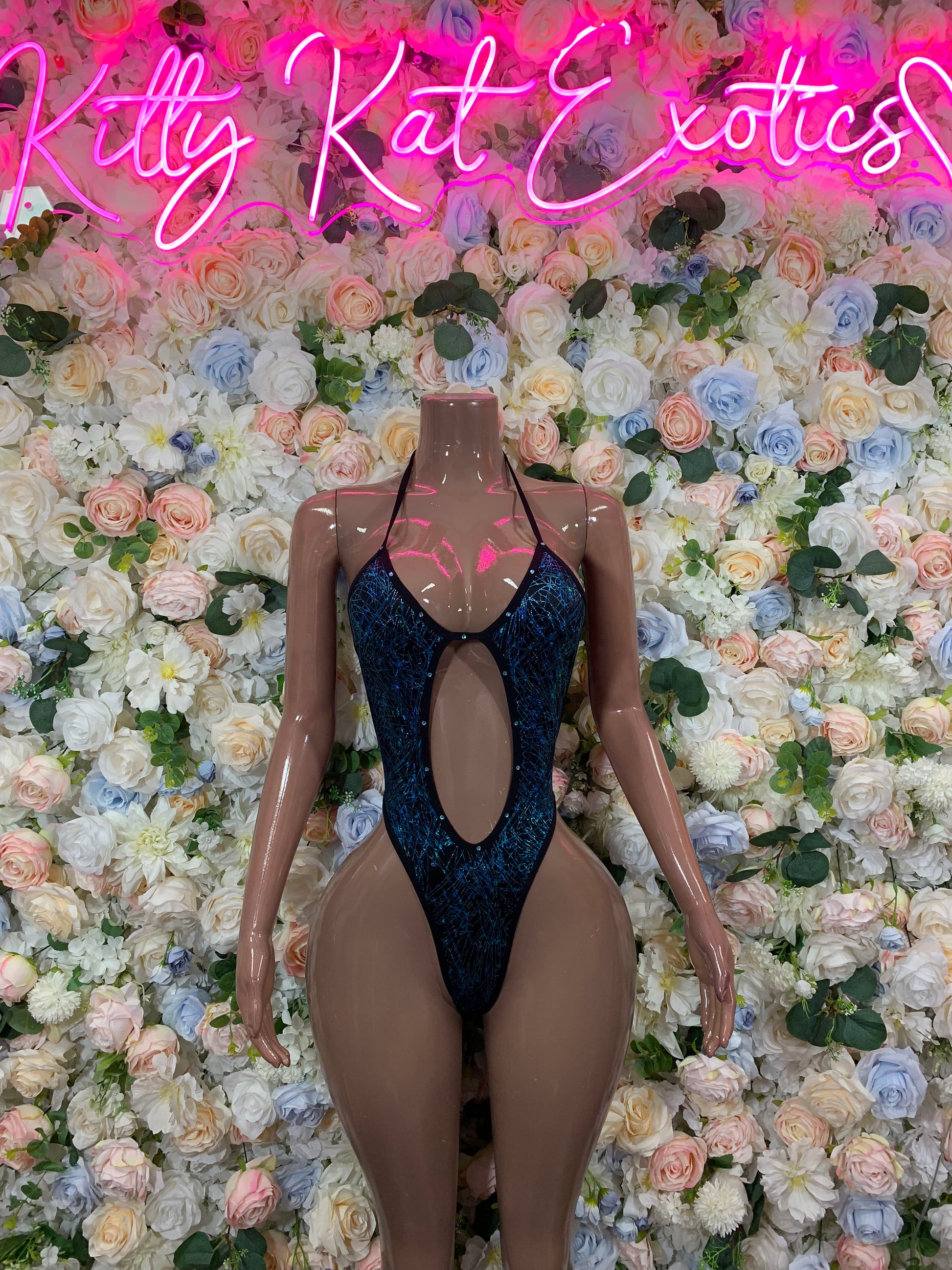 Blue metallic one-piece bodysuit with central oval cutout and high-cut legs