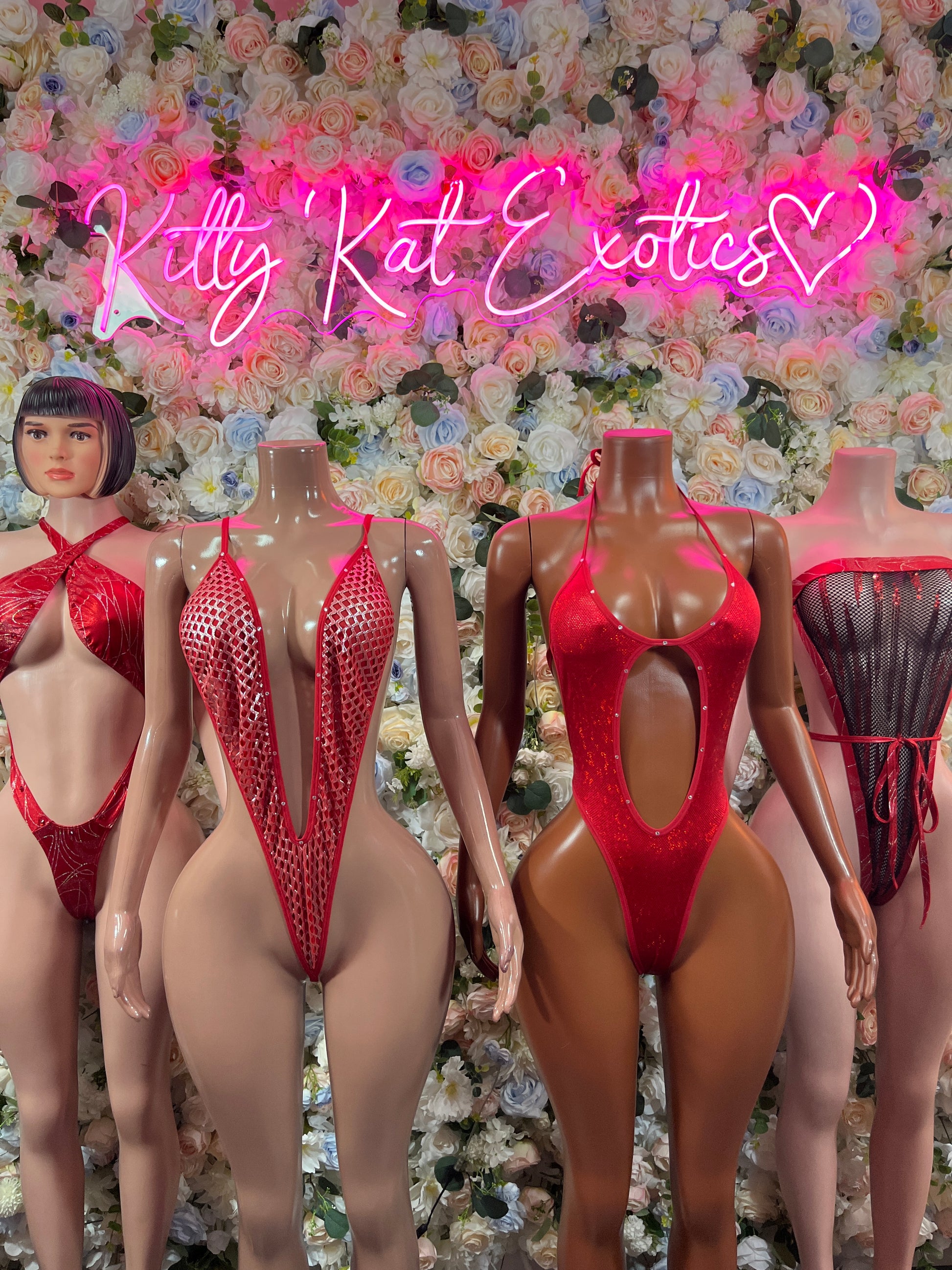 Red halter one-piece bodysuit with high-leg cut, shown on mannequins