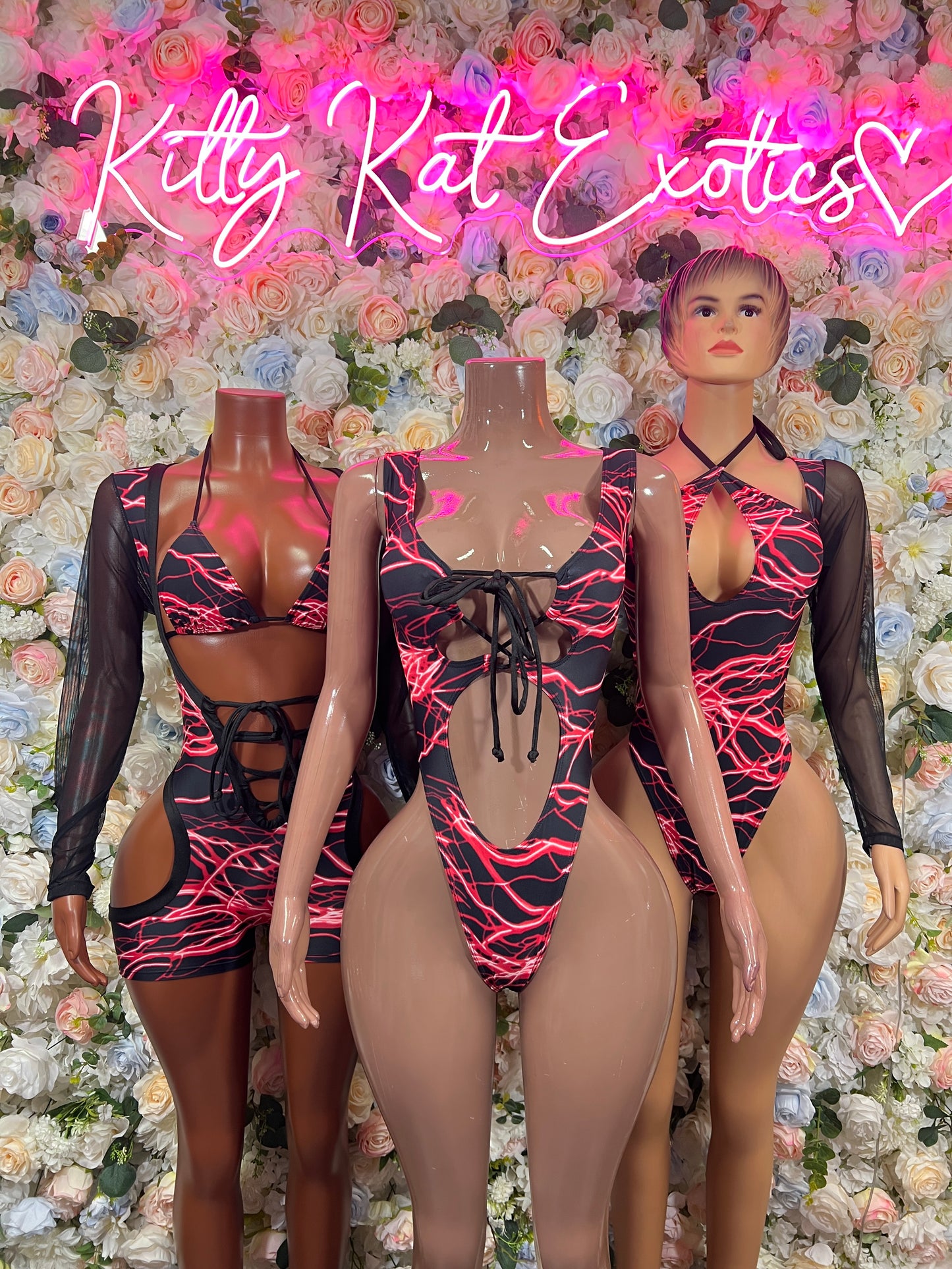 Black mesh one-piece bodysuit with red lightning print, long sleeves and lace-up straps