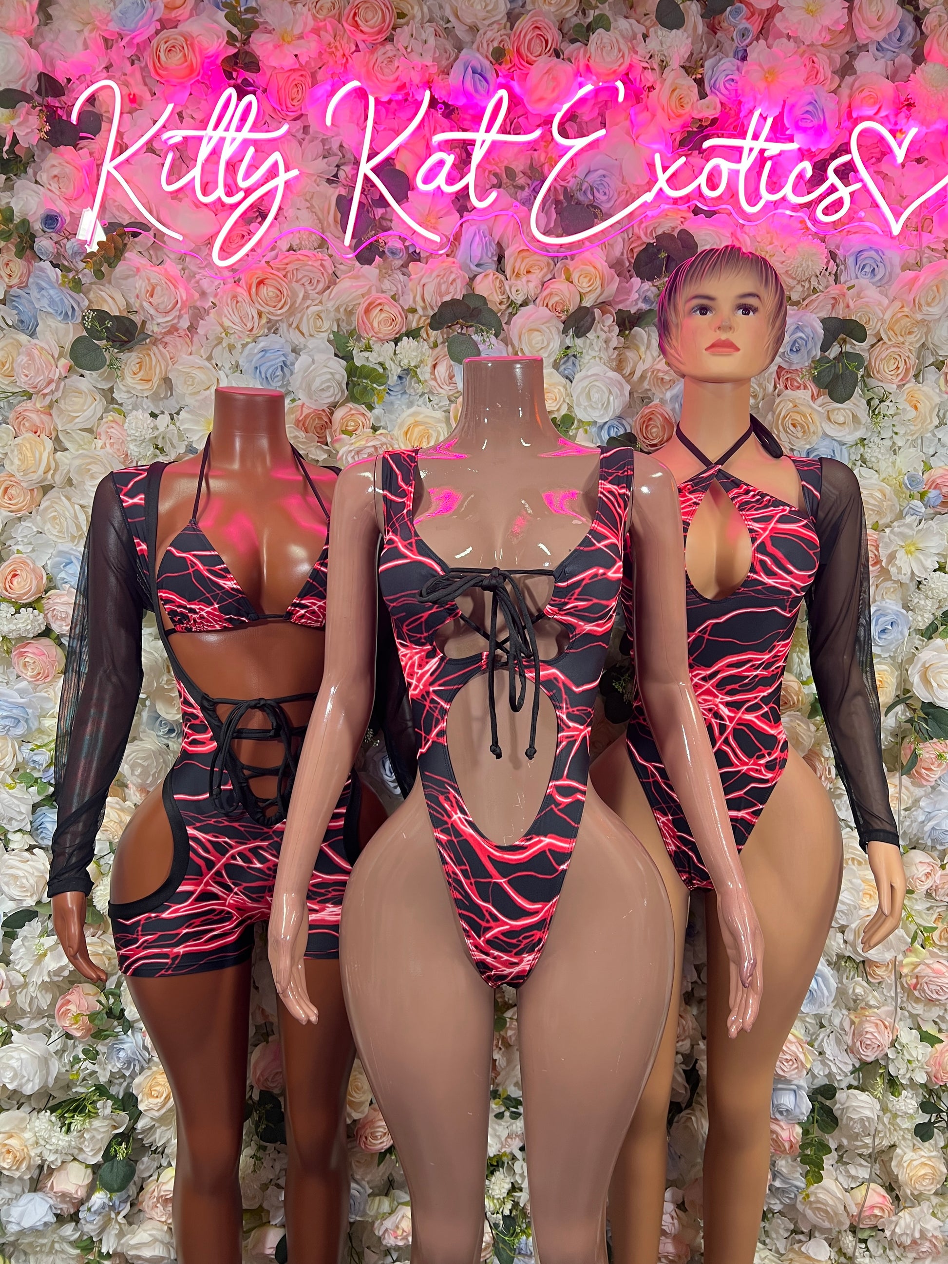 Black mesh one-piece bodysuit with red lightning print, long sleeves and lace-up straps