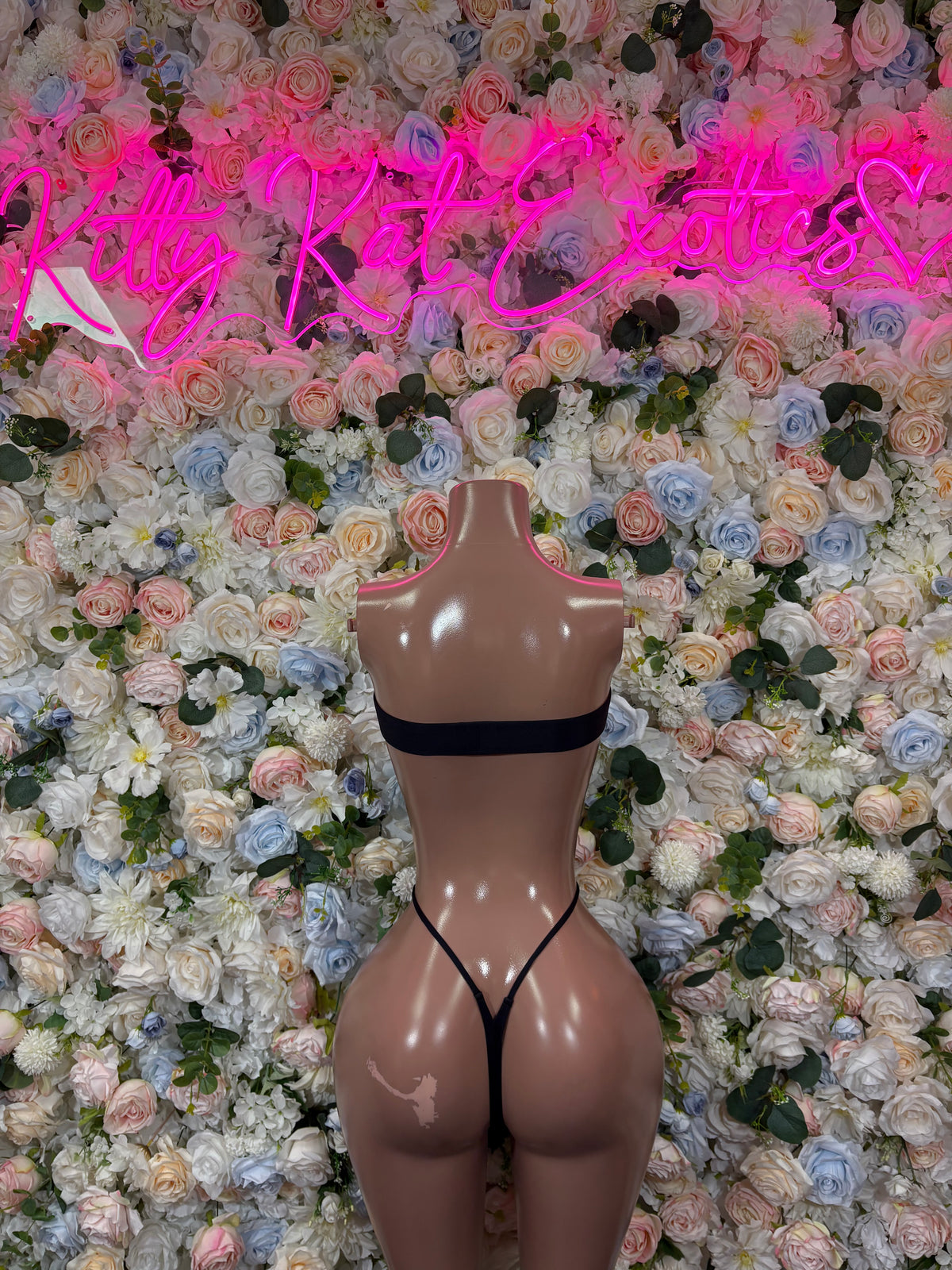Black fishnet bodysuit with V-front and thong-cut legs on mannequin
