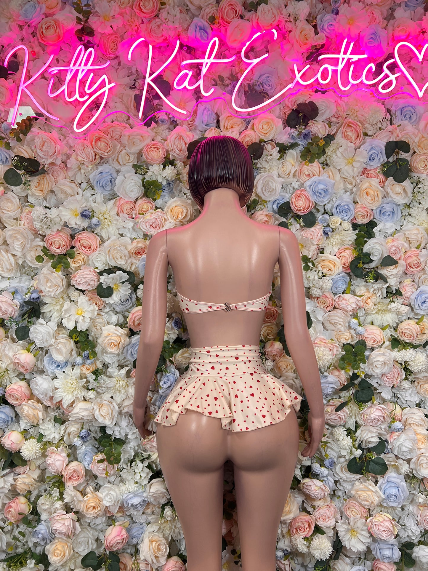 Back view cream polka-dot hearts two-piece: ruffled mini skirt and bandeau top