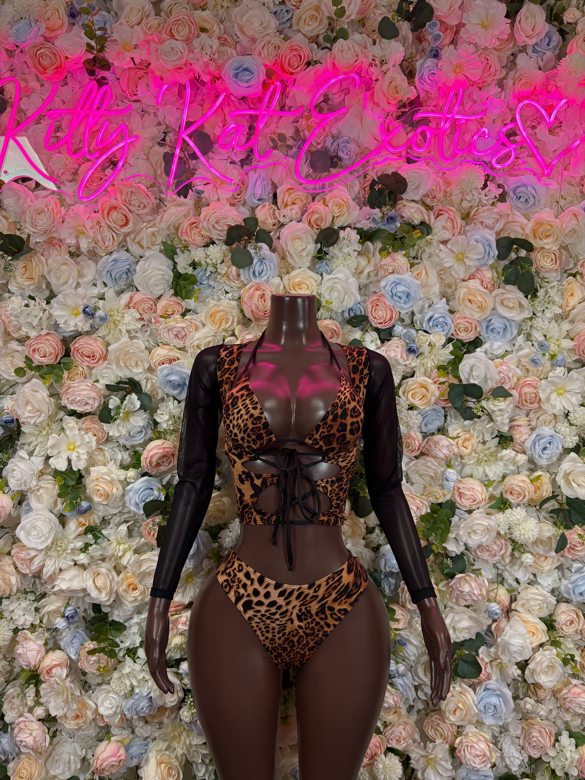 Leopard print long-sleeve bodysuit with black mesh sleeves and low-cut thong back