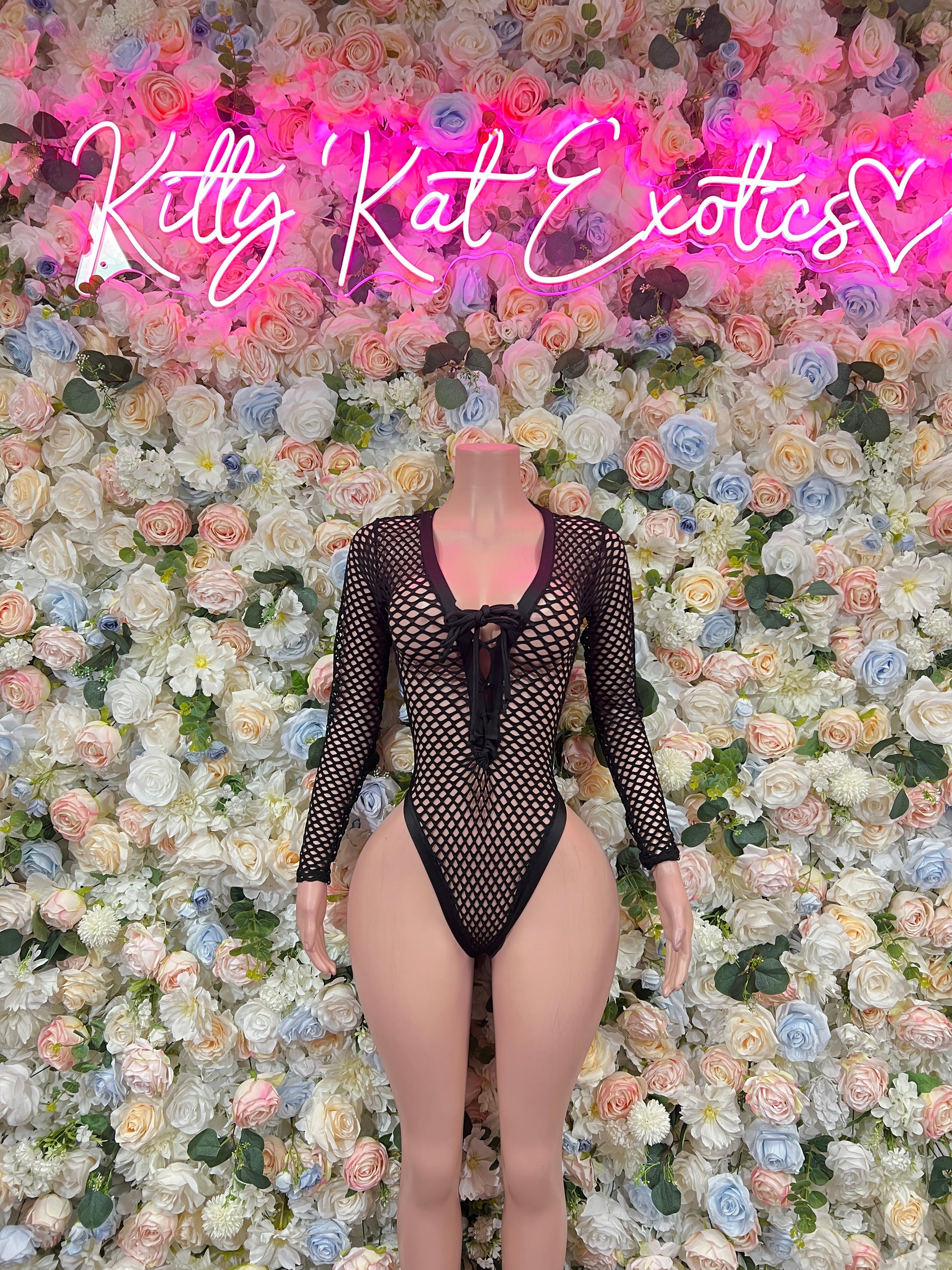 Black fishnet bodysuit with long sleeves, V-neck, and chest tie