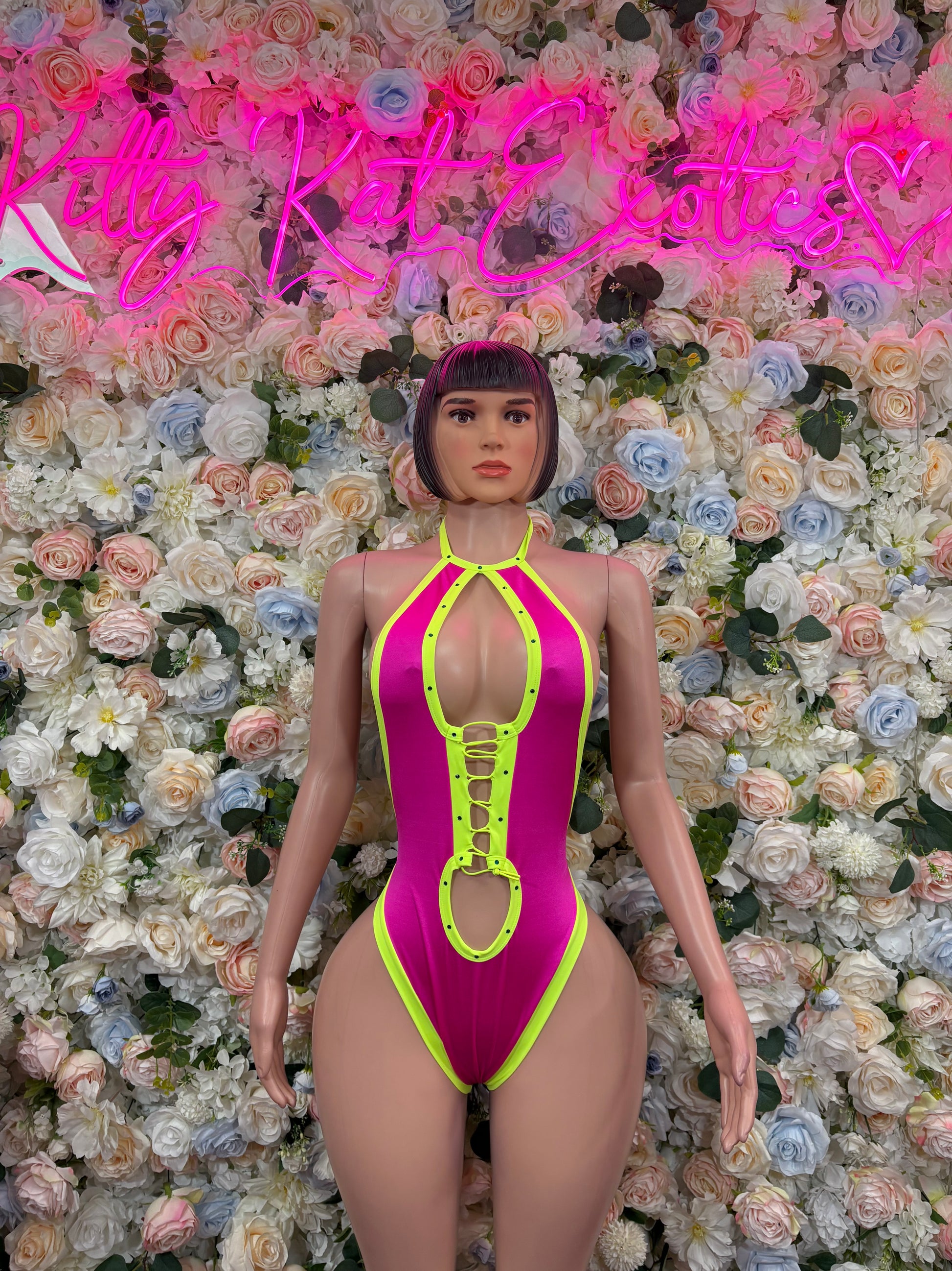 Neon pink and green thong bodysuit with halter neckline, front cutouts