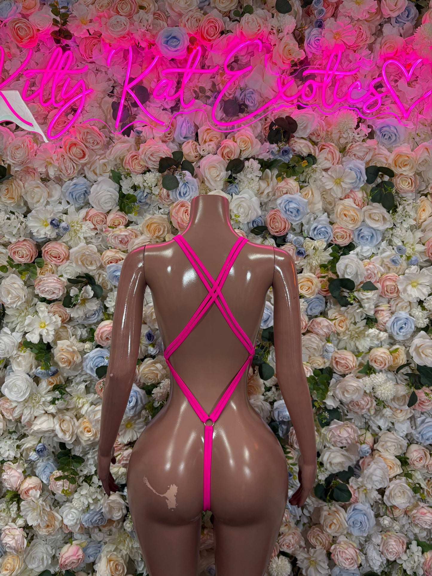 Pink rhinestone bodysuit back with crisscross straps and high-cut leg