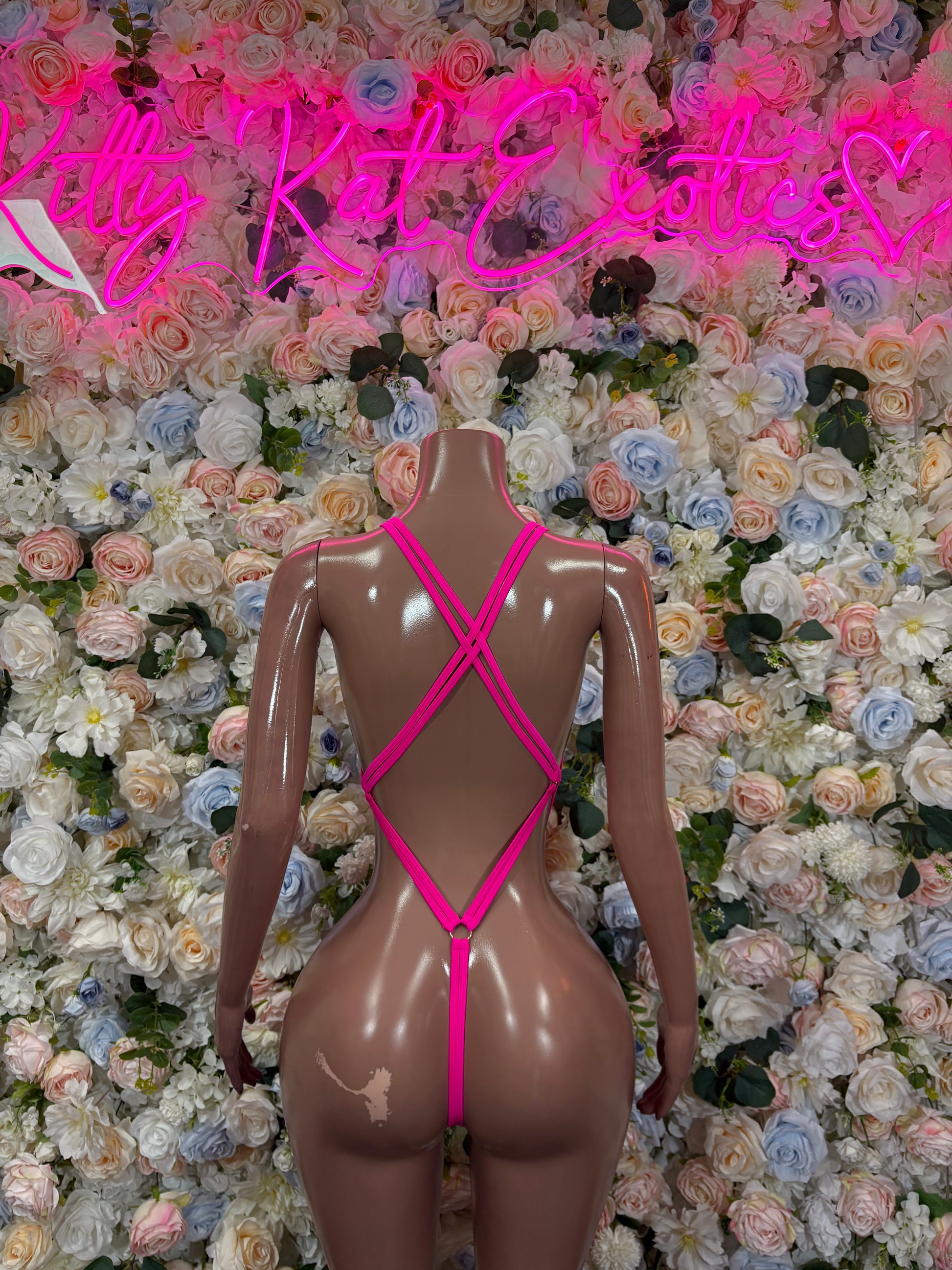 Pink rhinestone bodysuit back with crisscross straps and high-cut leg